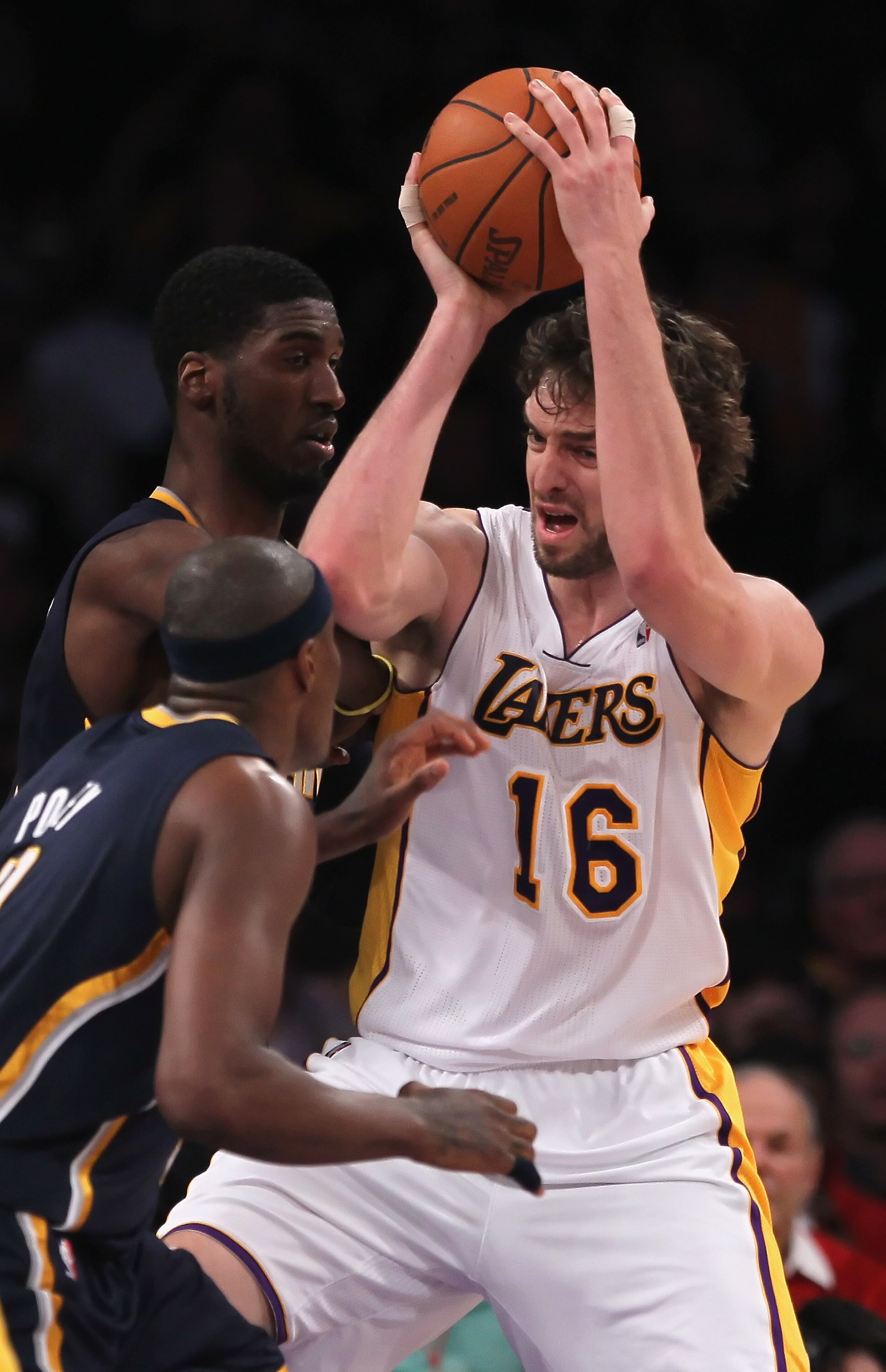 LOS ANGELES, CA - NOVEMBER 28:  Pau Gasol #16 of the Los Angeles Lakers is guarded by Roy Hibbert #55 and  T.J. Ford #5 of the Indiana Pacers during the second quarter at Staples Center on November 28, 2010 in Los Angeles, California. NOTE TO USER: User e