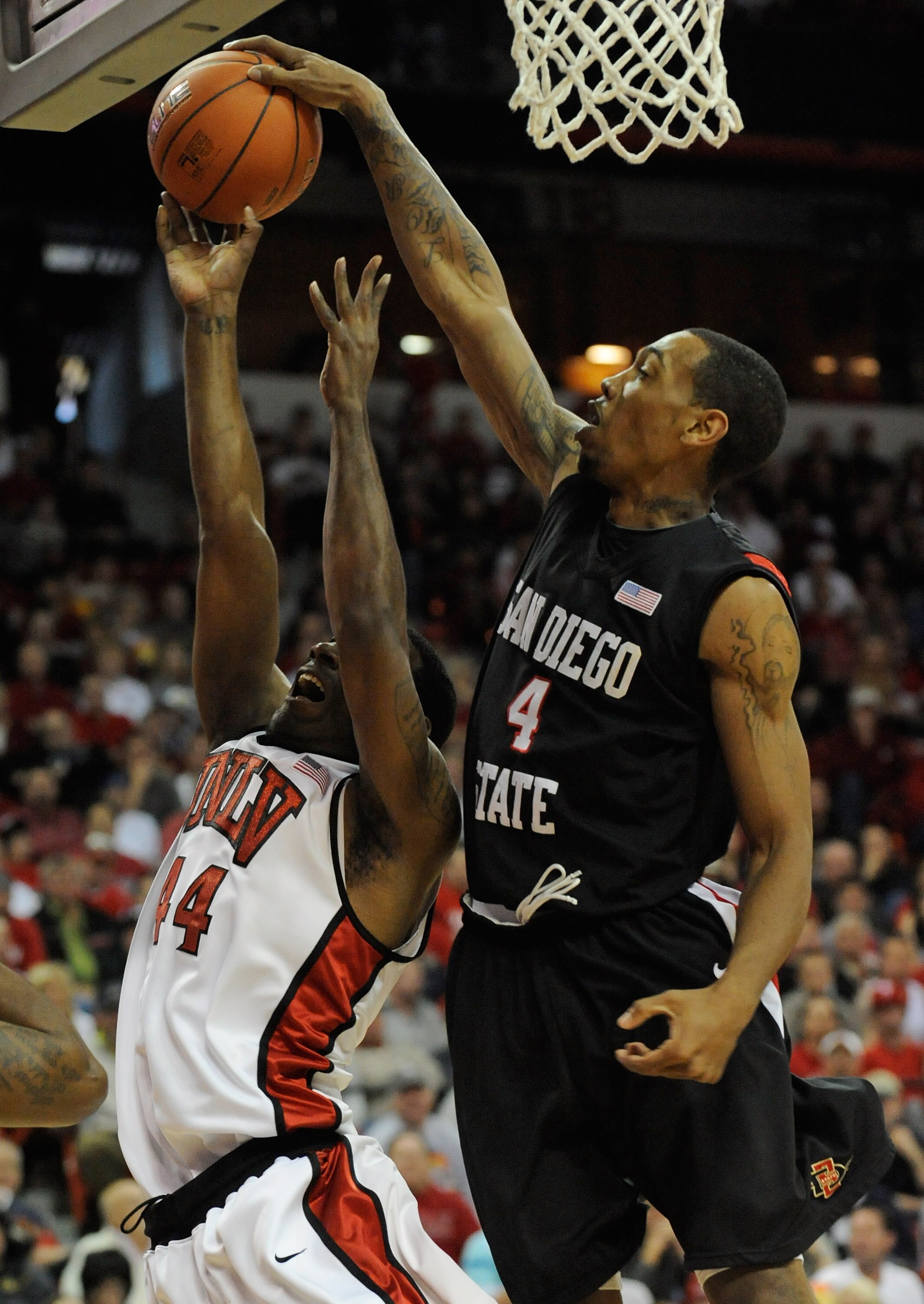 LAS VEGAS - MARCH 13:  Malcolm Thomas #4 of the San Diego State Aztecs blocks a shot by Darris Santee #44 of the UNLV Rebels during the championship game of the Conoco Mountain West Conference Basketball tournament at the Thomas & Mack Center March 13, 20