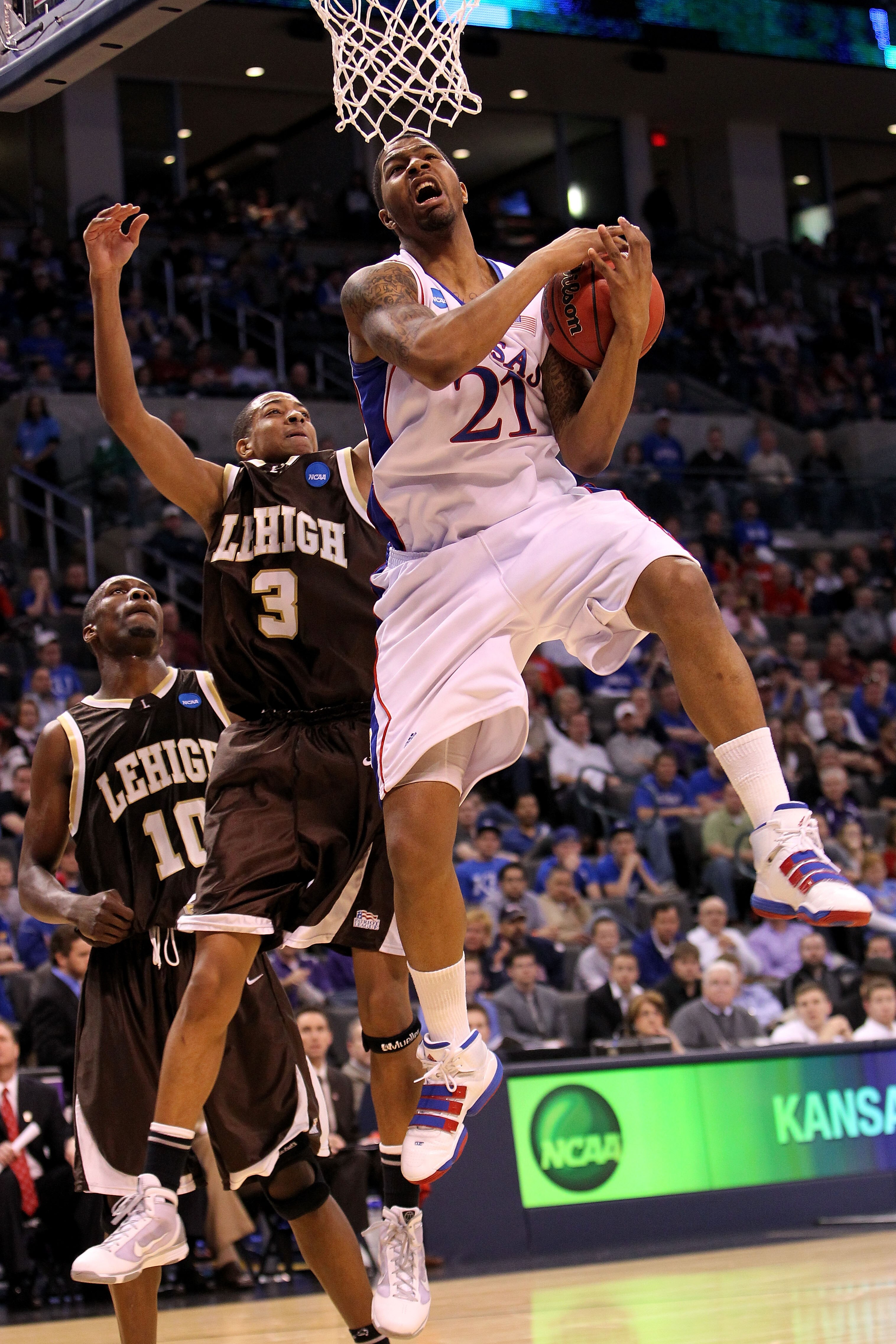 OKLAHOMA CITY - MARCH 18:  Markieff Morris #21 of the Kansas Jayhawks grabs a rebound against CJ McCollum #3 of the Lehigh Mountain Hawks during the first round of the 2010 NCAA men's basketball tournament at Ford Center on March 18, 2010 in Oklahoma City