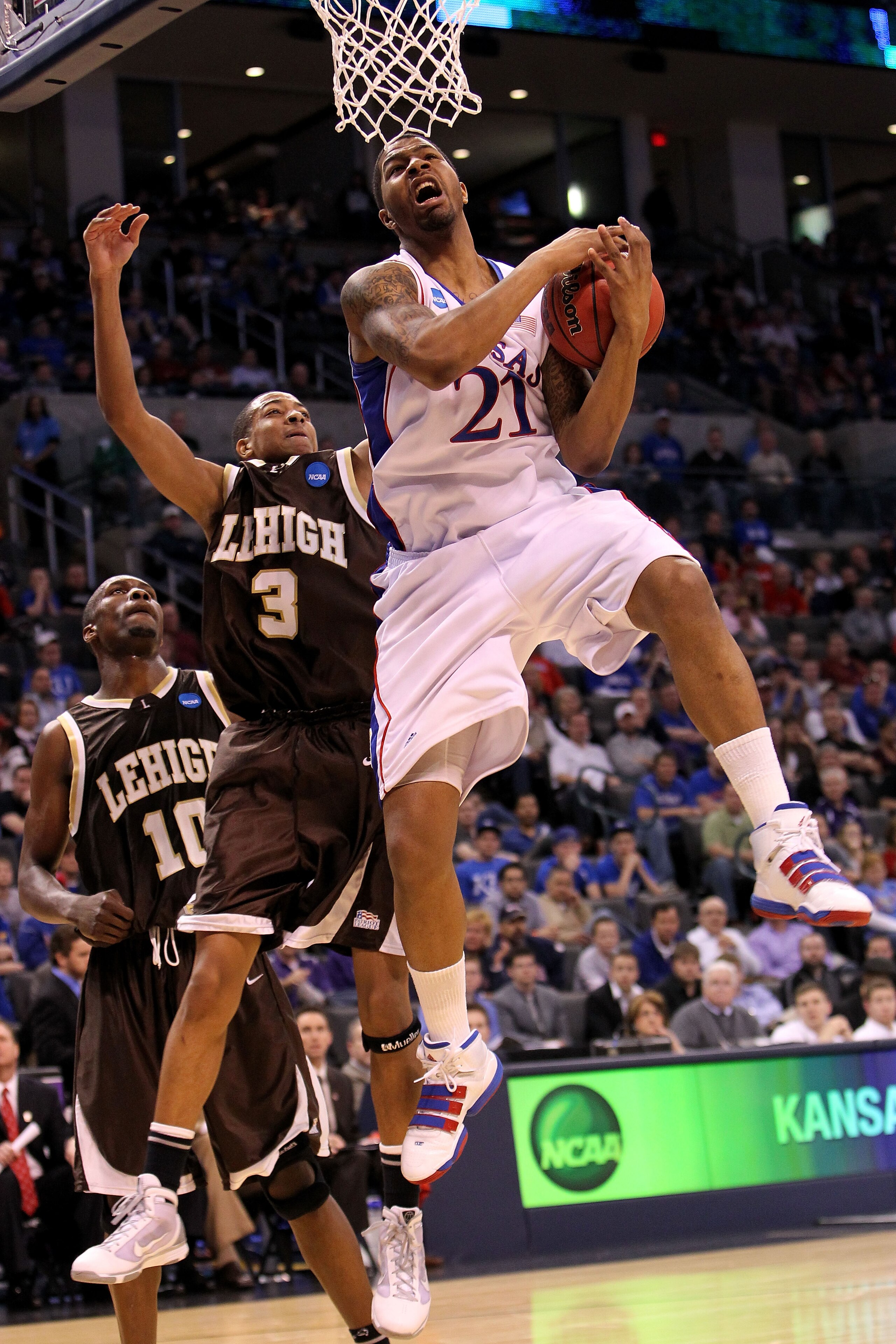 OKLAHOMA CITY - MARCH 18:  Markieff Morris #21 of the Kansas Jayhawks grabs a rebound against CJ McCollum #3 of the Lehigh Mountain Hawks during the first round of the 2010 NCAA men's basketball tournament at Ford Center on March 18, 2010 in Oklahoma City