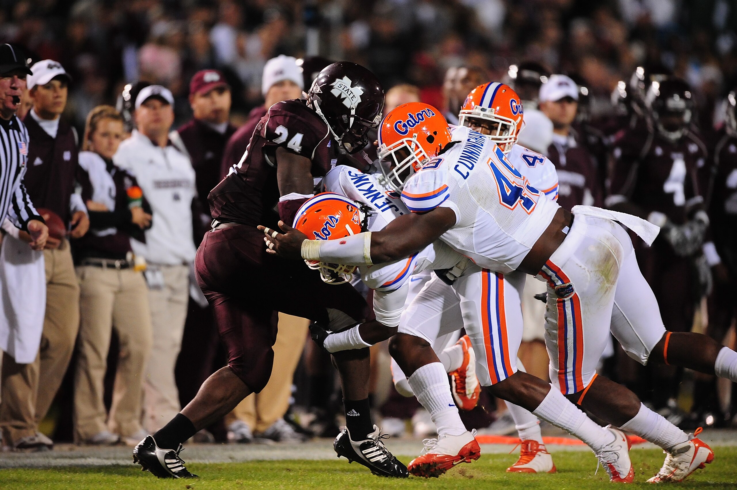STARKVILLE, MS - OCTOBER 24:  Running back Anthony Dixon # 24 of the Mississippi State Bulldogs is tackled by Jermaine Cunningham # 49 and Janoris Jenkins # 1 of the Florida Gators, at Davis Wade Stadium on  October 24, 2009 in Starkville, Mississippi  (P
