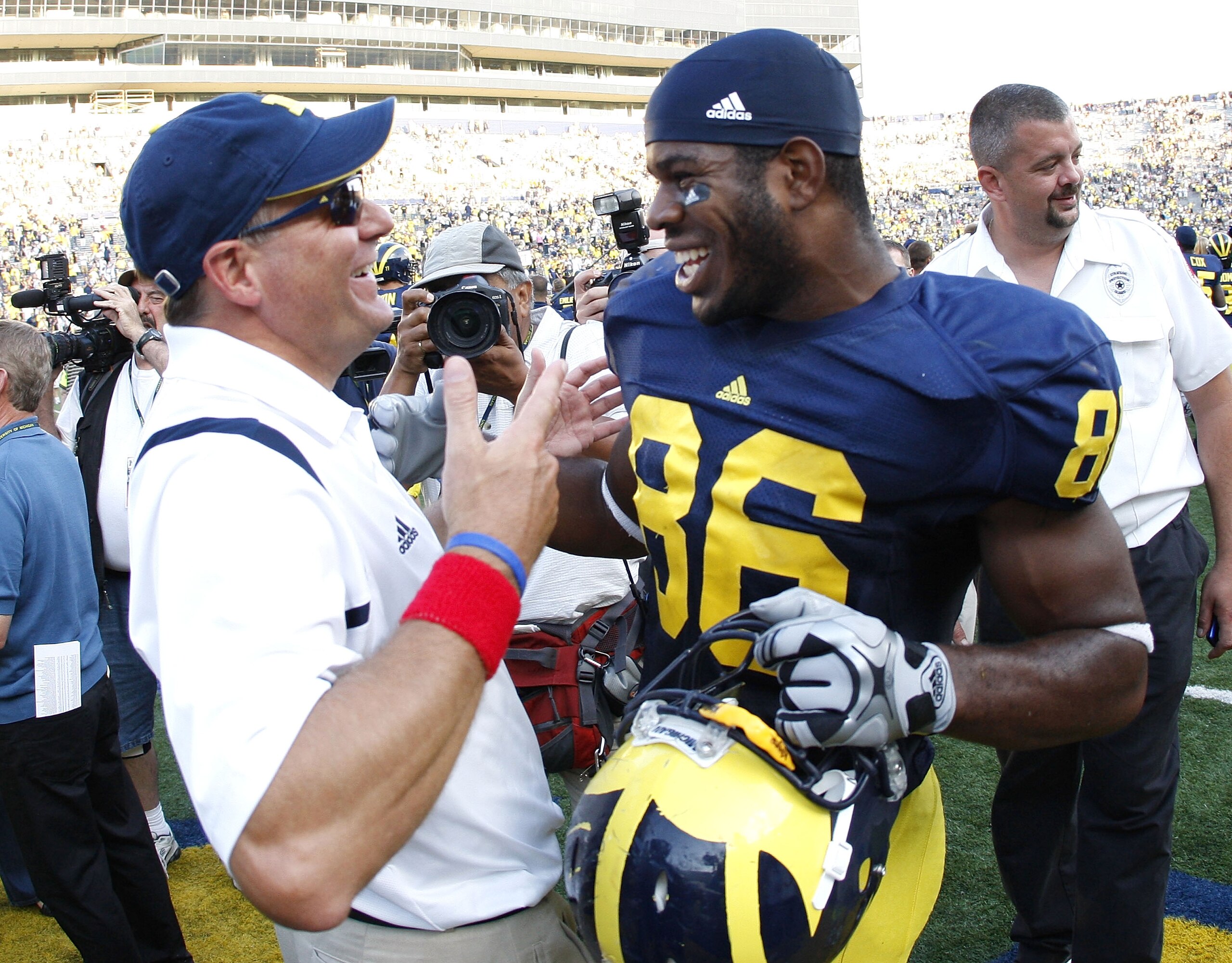 ANN ARBOR, MI - SEPTEMBER 05:  Head coach Rich Rodriguez of the Michigan Wolverines talks with Kevin Koger #86 after beating the Western Michigan Broncos 31-7 on September 5, 2009 at Michigan Stadium in Ann Arbor, Michigan.  (Photo by Gregory Shamus/Getty
