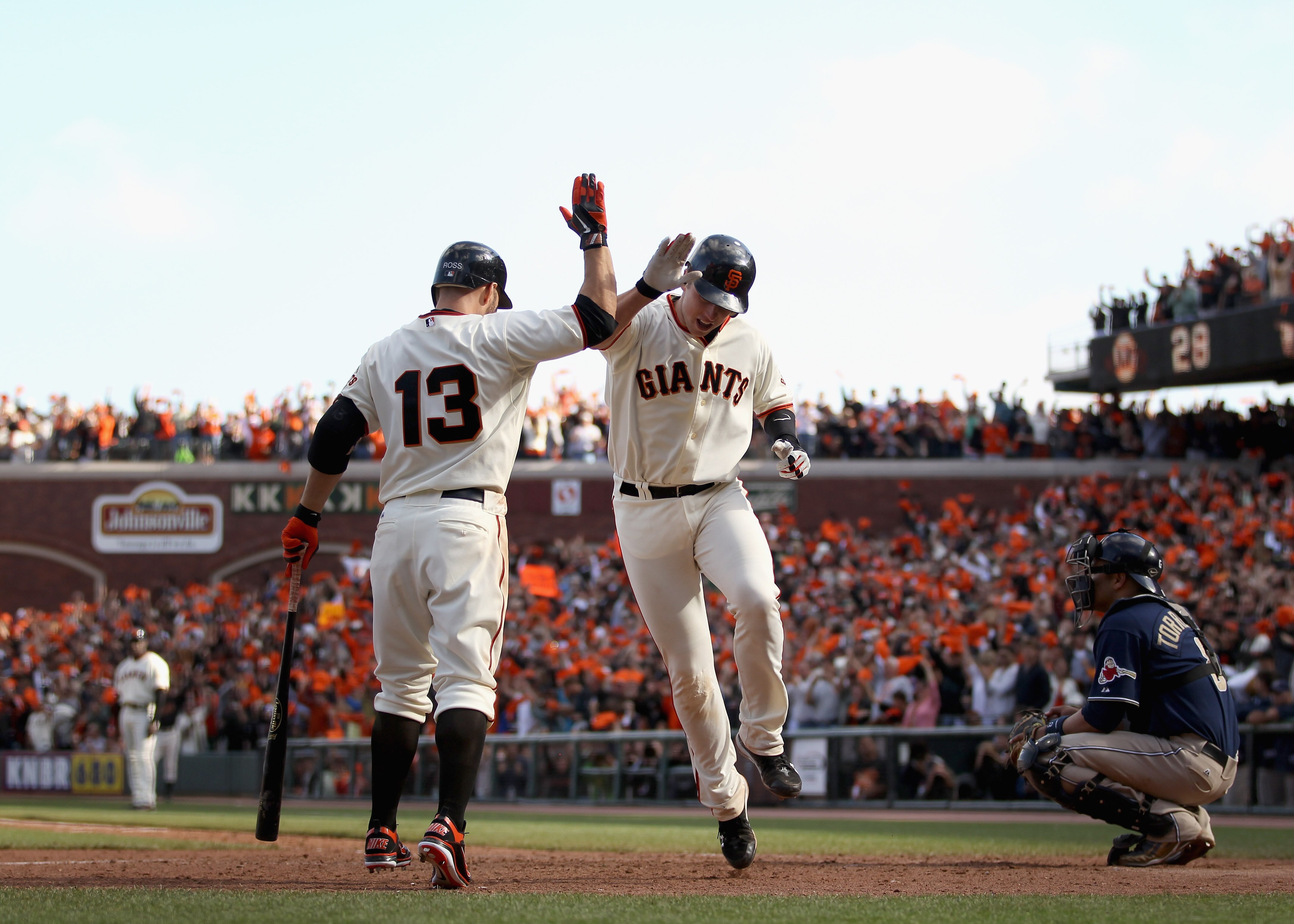 SAN FRANCISCO - OCTOBER 03:  Buster Posey #28 of the San Francisco Giants is congratulated by Cody Ross #13 after he hit a home run in the eighth inning of their game against the San Diego Padres at AT&T Park on October 3, 2010 in San Francisco, Californi