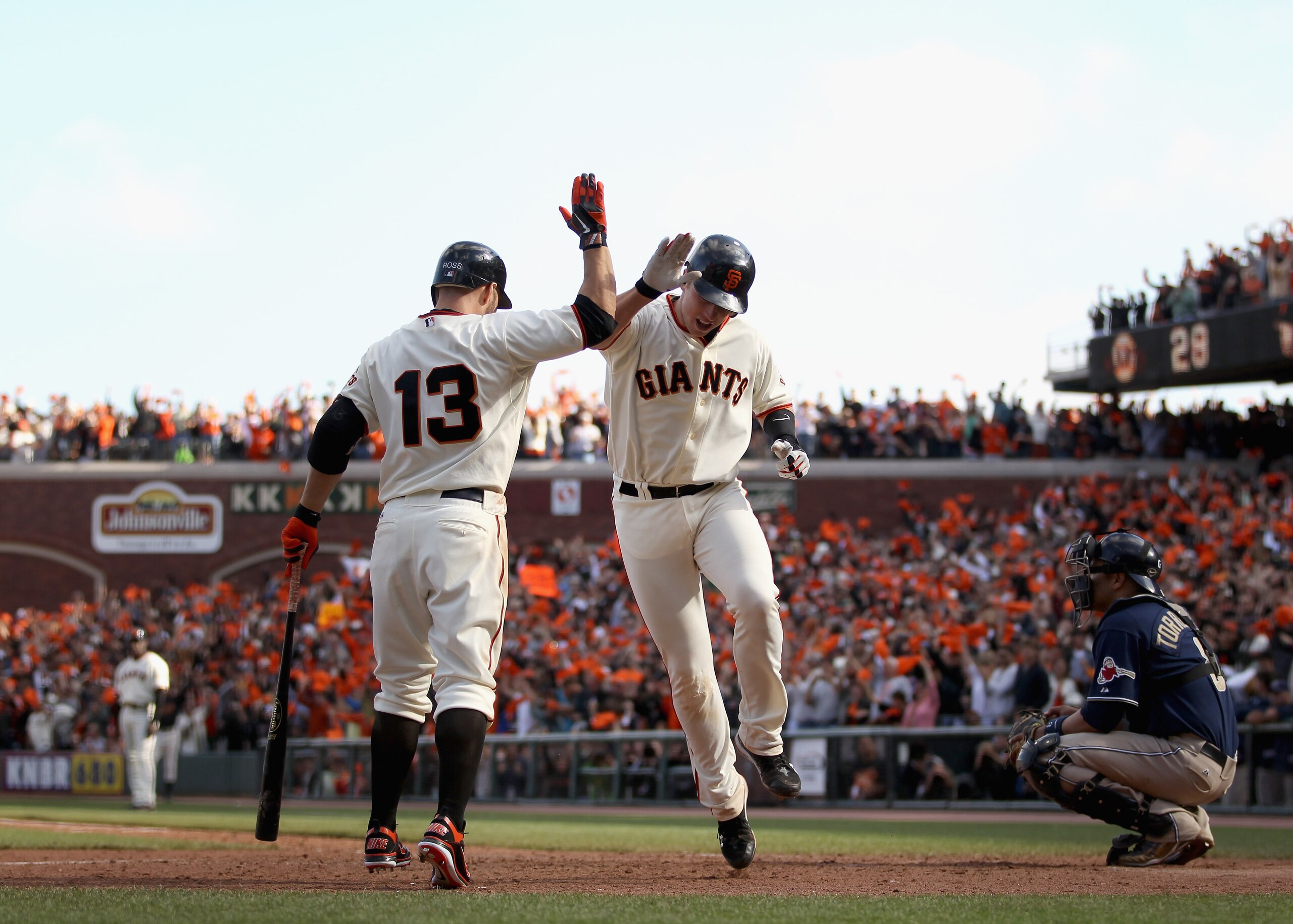 SAN FRANCISCO - OCTOBER 03:  Buster Posey #28 of the San Francisco Giants is congratulated by Cody Ross #13 after he hit a home run in the eighth inning of their game against the San Diego Padres at AT&T Park on October 3, 2010 in San Francisco, Californi