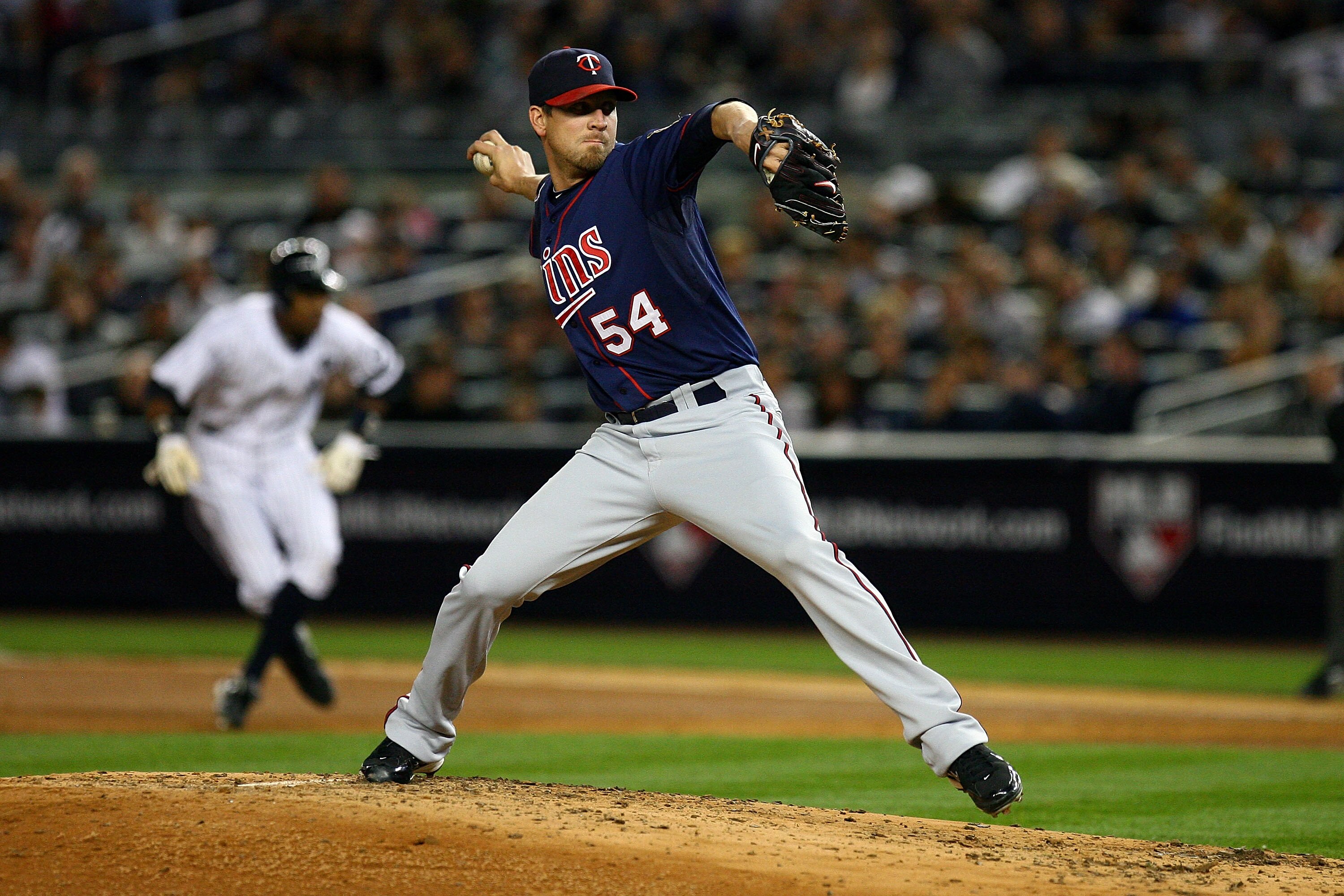 NEW YORK - OCTOBER 09:  Matt Guerrier #54 of the Minnesota Twins throws a pitch against the New York Yankees during Game Three of the ALDS part of the 2010 MLB Playoffs at Yankee Stadium on October 9, 2010 in the Bronx borough of New York City.  (Photo by