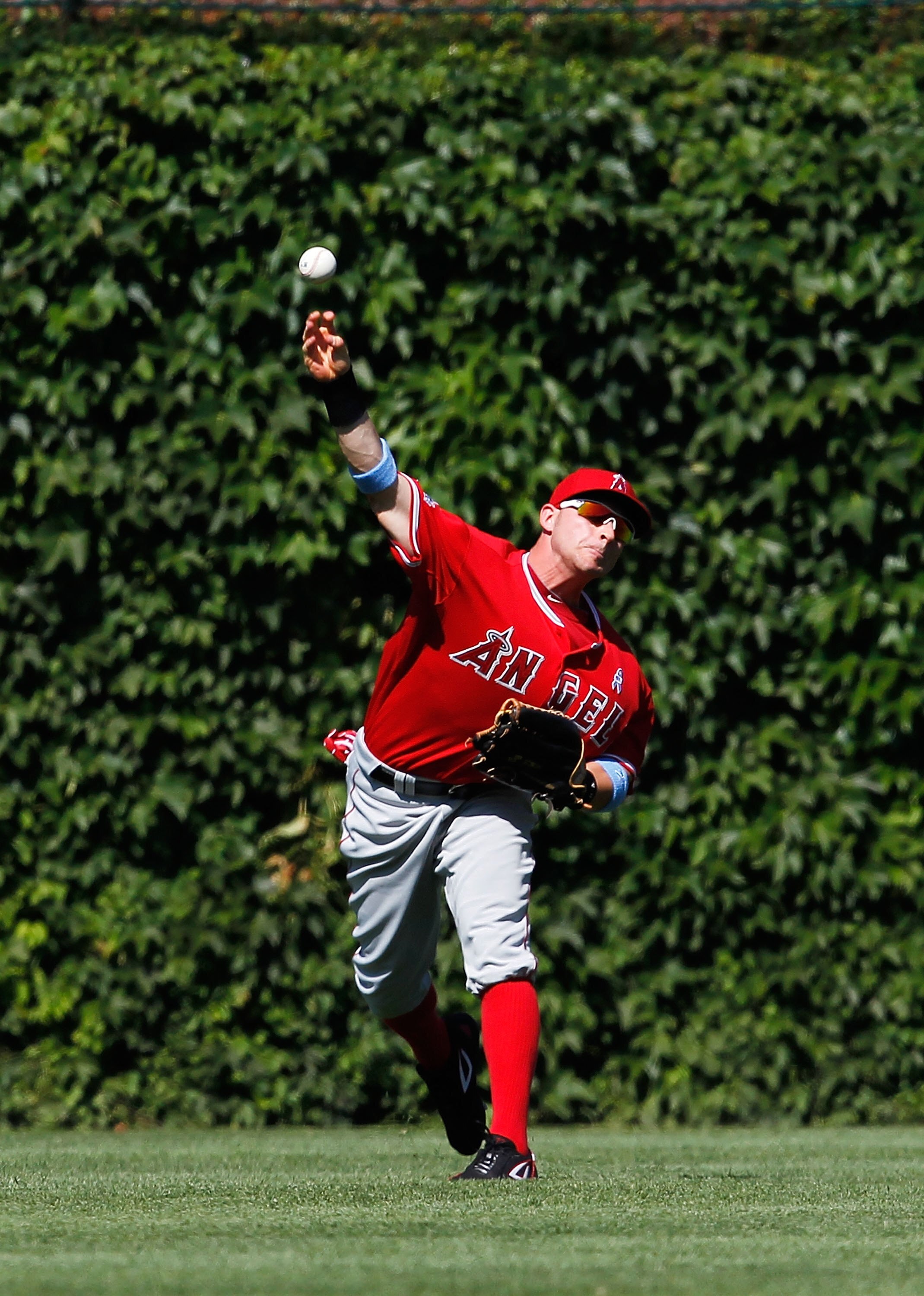 CHICAGO - JUNE 20: Reggie Willits #77 of the Los Angeles Angels of Anaheim throws the ball to the infield against the Chicgo Cubs at Wrigley Field on June 20, 2010 in Chicago, Illinois. The Cubs defeated the Angels 12-1. (Photo by Jonathan Daniel/Getty Im