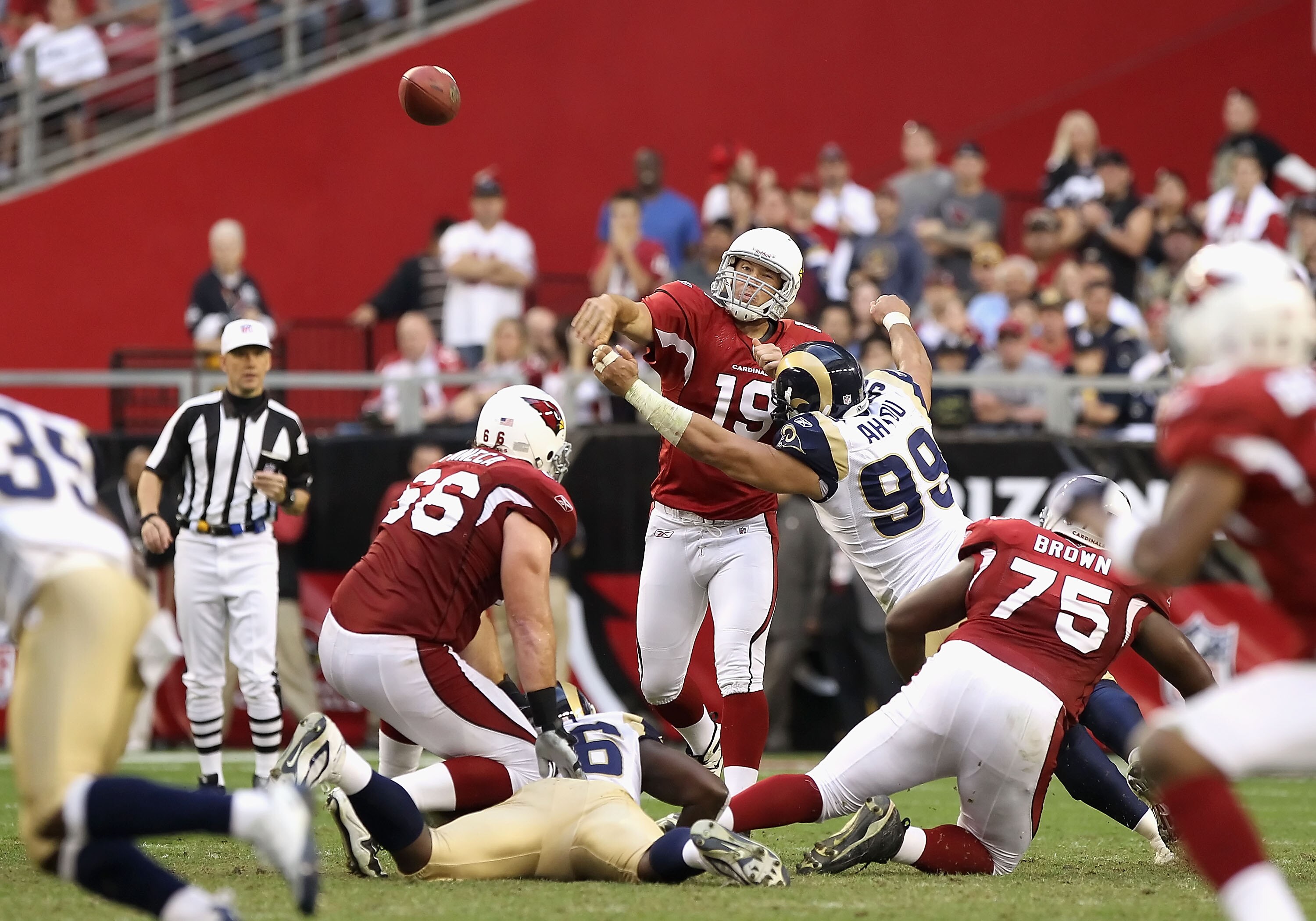 GLENDALE, AZ - DECEMBER 05:  Quarterback John Skelton #19 of the Arizona Cardinals throws a pass under pressure from C.J. Ah You #99 of the St. Louis Rams during the fourth quarter of the NFL game at the University of Phoenix Stadium on December 5, 2010 i