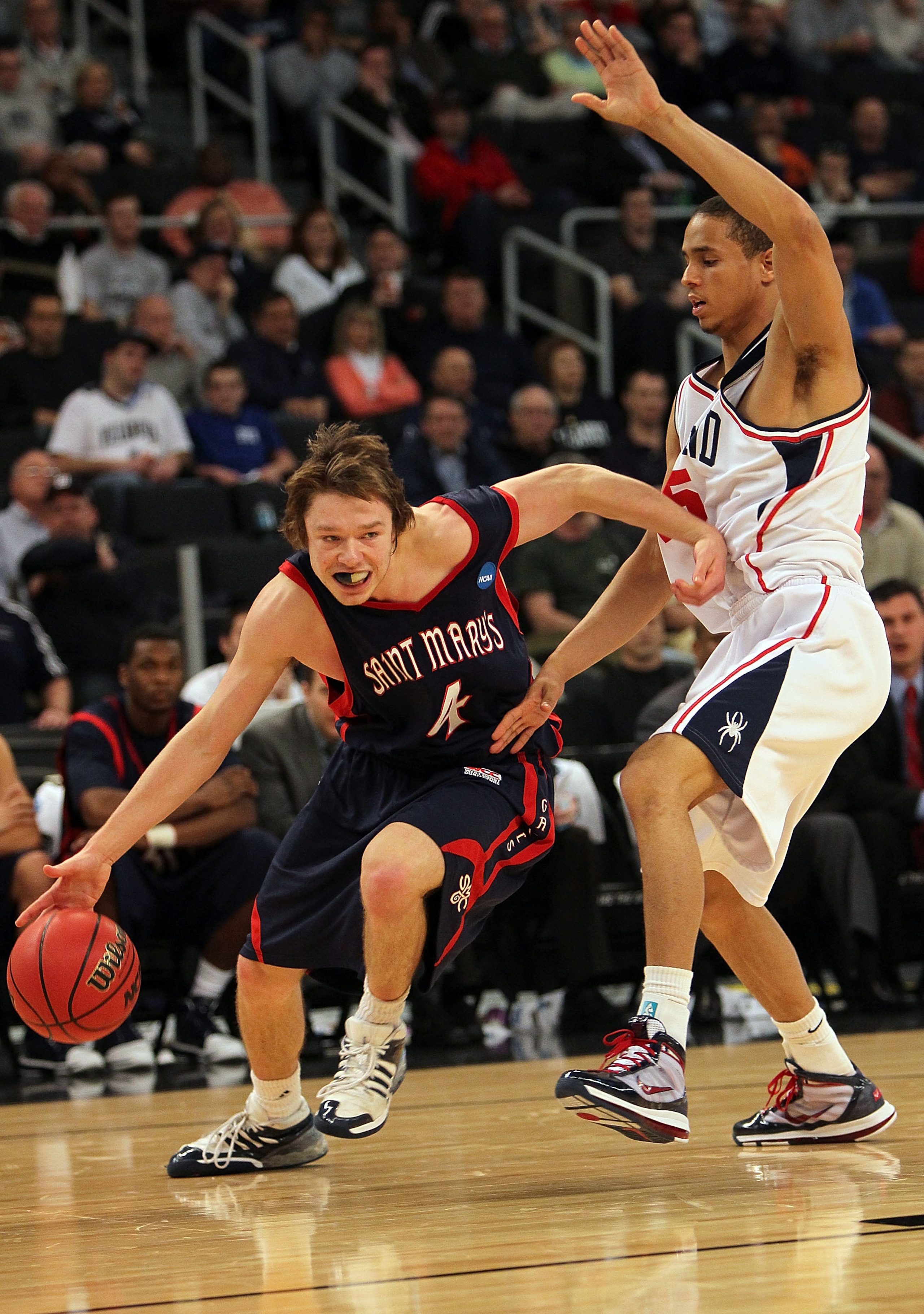PROVIDENCE, RI - MARCH 18:  Matthew Dellavedova #4 of the Saint Mary's Gaels drives to the basket against the defense of Francis-Cedric Martel #15 of the Richmond Spiders during the first round of the 2010 NCAA men's basketball tournament at Dunkin' Donut