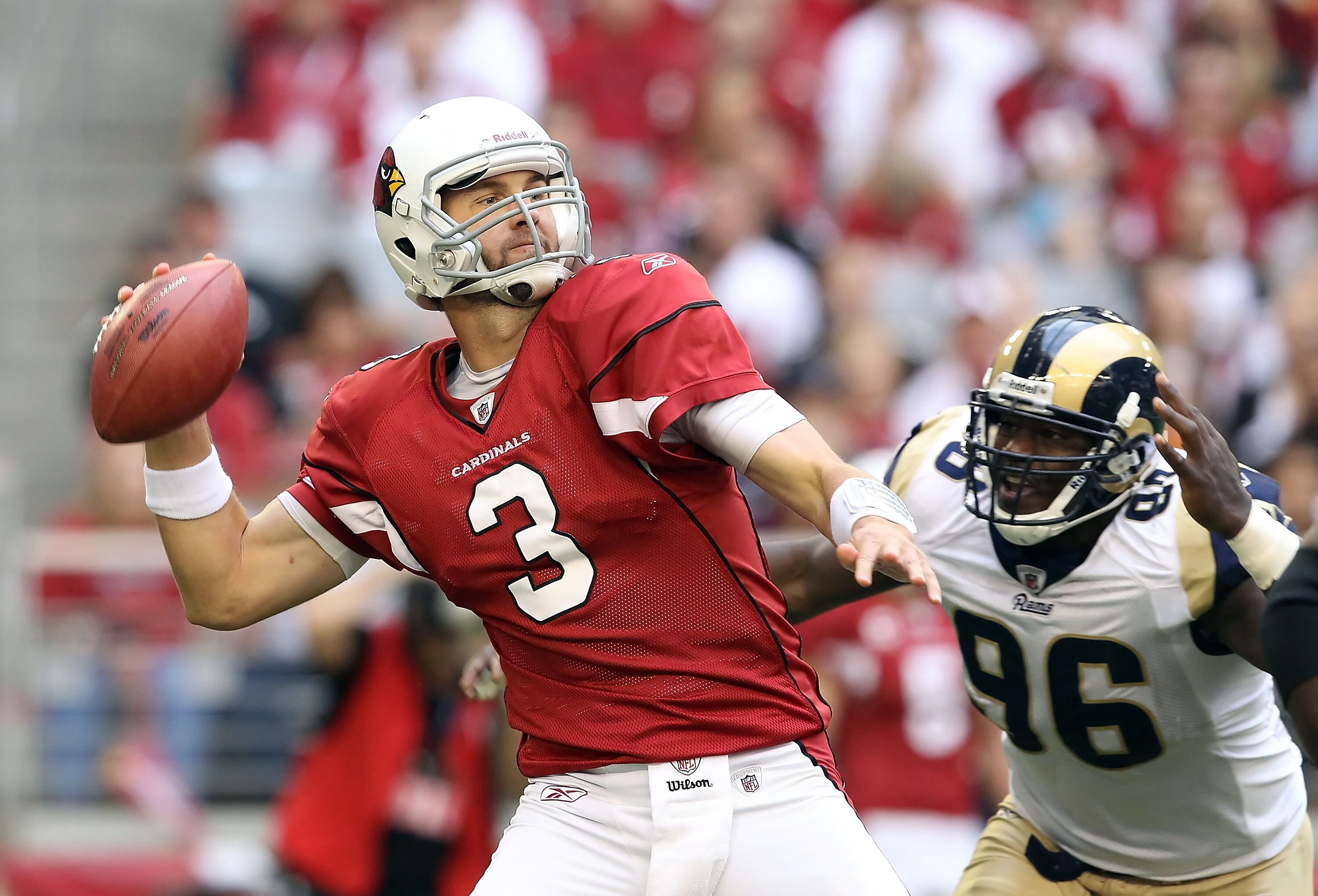 GLENDALE, AZ - DECEMBER 05:  Quarterback Derek Anderson #3 of the Arizona Cardinals throws a pass under pressure from James Hall #96 of the St. Louis Rams during the NFL game at the University of Phoenix Stadium on December 5, 2010 in Glendale, Arizona.  