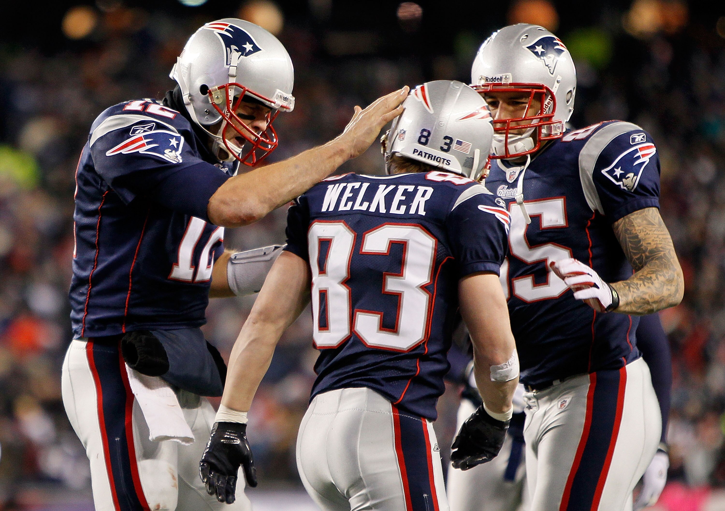 FOXBORO, MA - DECEMBER 06:  (L-R) Tom Brady #12, Wes Welker #83 and Aaron Hernandez #85 of the New England Patriots celebrate after Welker scored a touchdown in the third quarter against the New York Jets at Gillette Stadium on December 6, 2010 in Foxboro