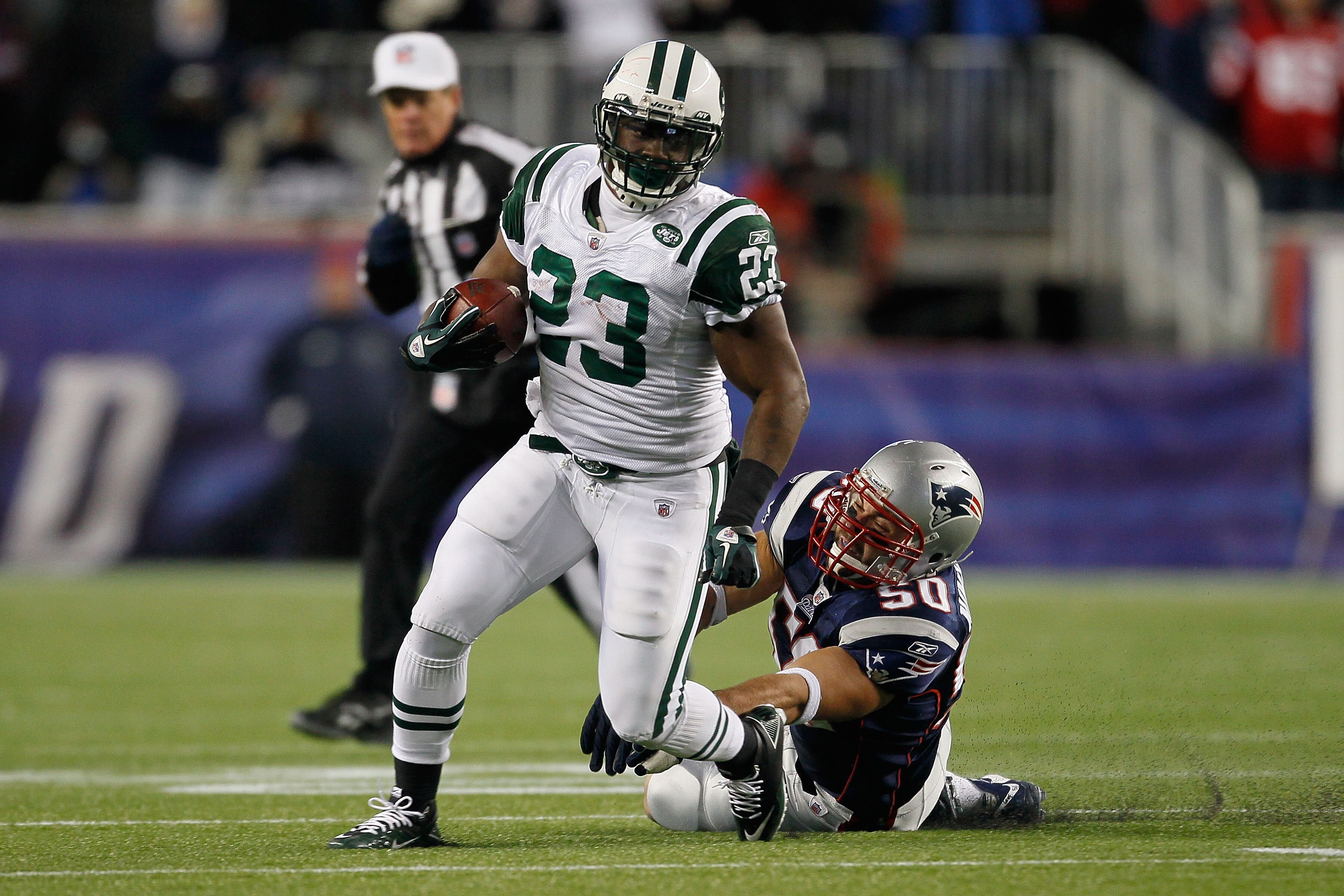 FOXBORO, MA - DECEMBER 06:  Shonn Greene #23 of the New York Jets runs the ball in the first half against Rob Ninkovich #50 of the New England Patriots at Gillette Stadium on December 6, 2010 in Foxboro, Massachusetts.  (Photo by Jim Rogash/Getty Images)