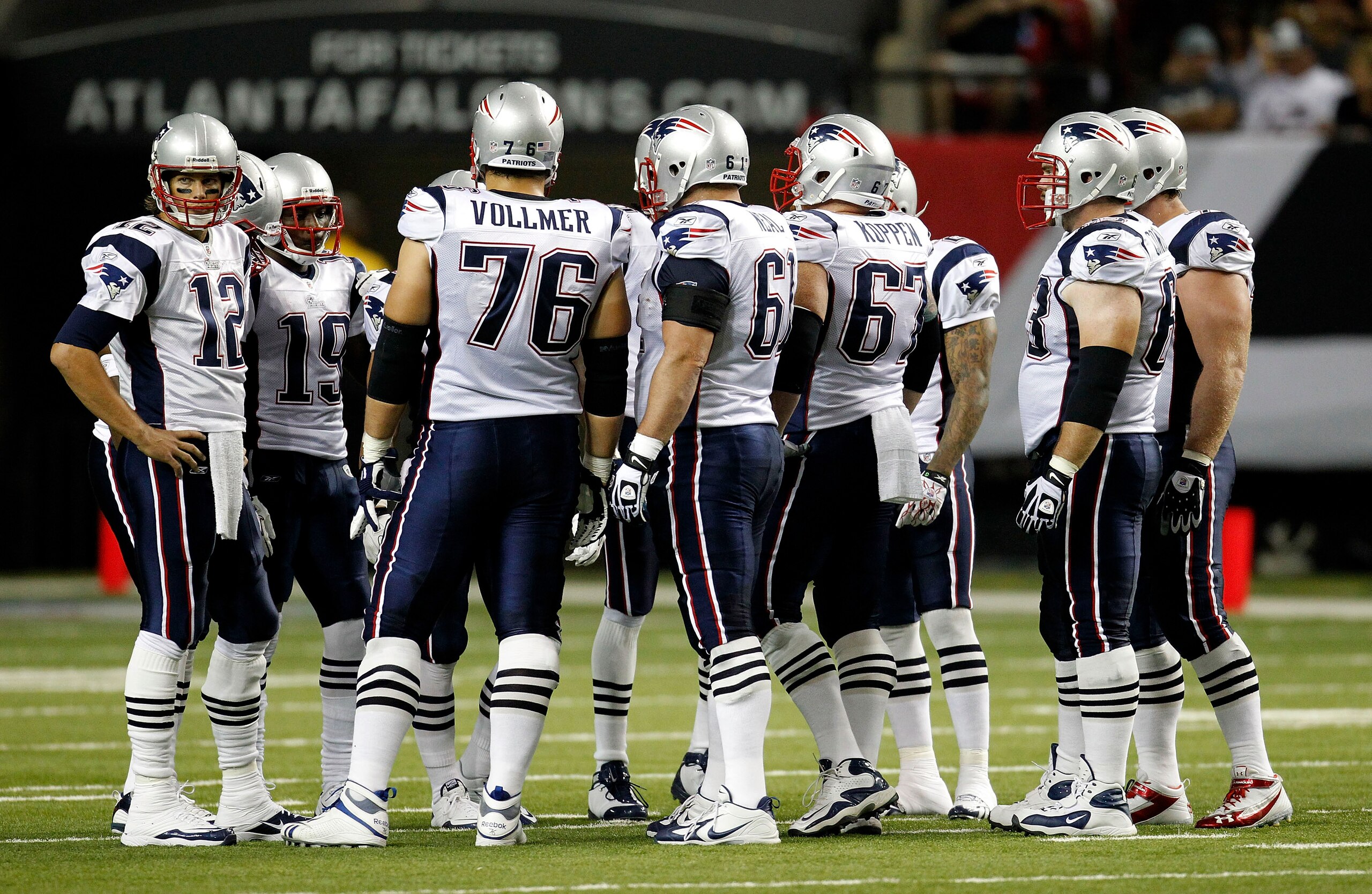 ATLANTA - AUGUST 19:  The New England Patriots offense, led by quarterback Tom Brady #12 (L), huddles before a play during the preseason game against the Atlanta Falcons at the Georgia Dome on August 19, 2010 in Atlanta, Georgia.  The Patriots beat the Fa