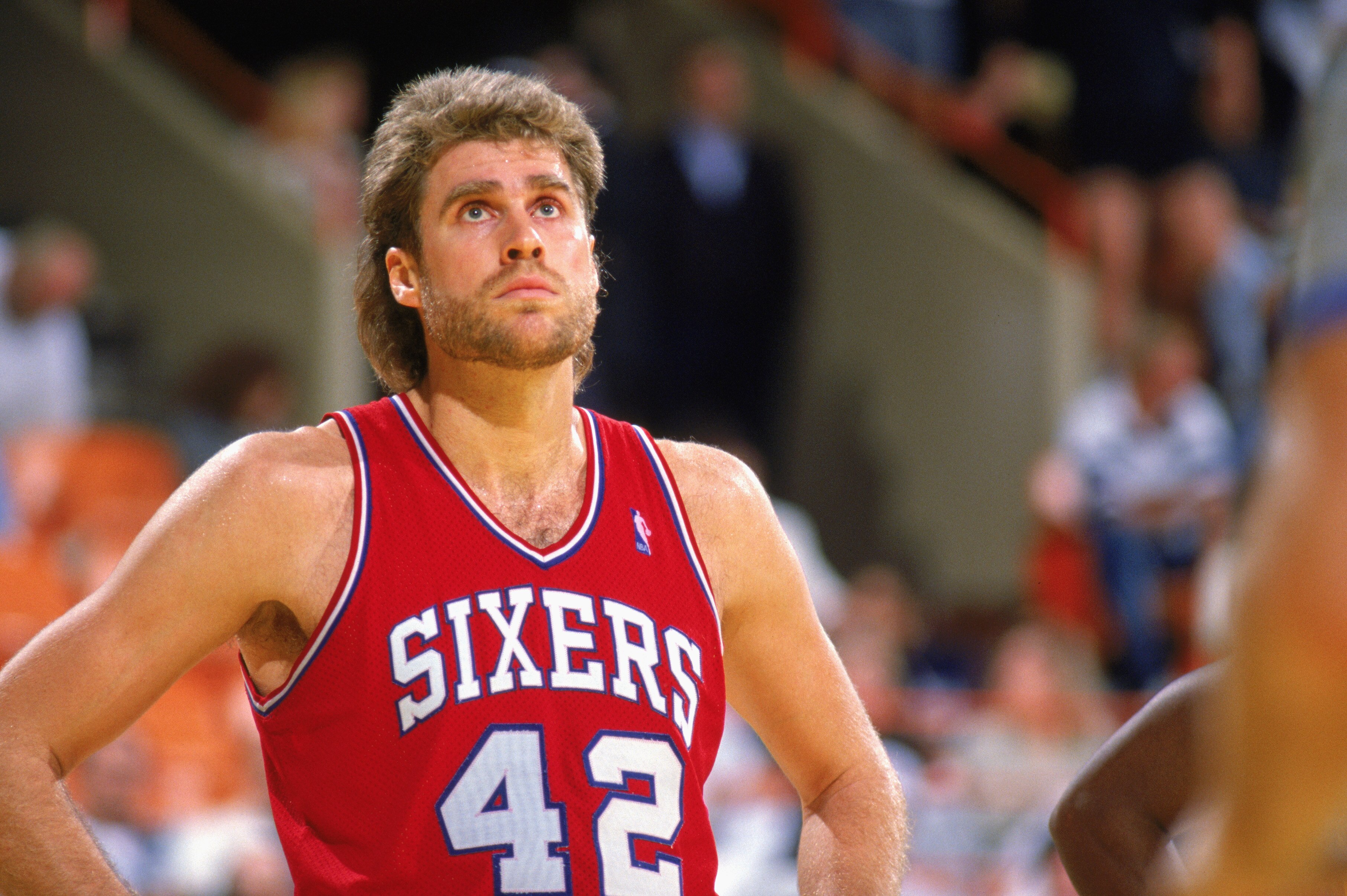 1989:  Mike Gminski #42 of the Philadelphia 76ers watches the 1989-1990 NBA season game.  (Photo by Mike Powell/Getty Images)
