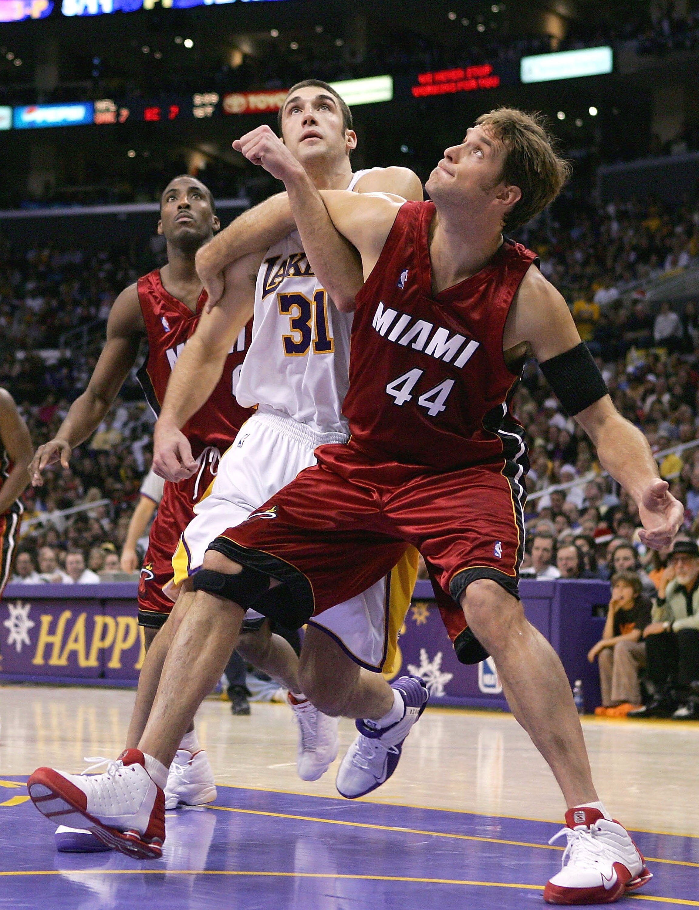 LOS ANGELES - DECEMBER 25:  Chris Mihm #31 of the Los Angeles Lakers and Christian Laettner #44 of the Miami Heat fight for a rebound on December 25, 2004 at Staples Center in Los Angeles, California. The Heat defeated the Lakers in overtime 104-102.  NOT