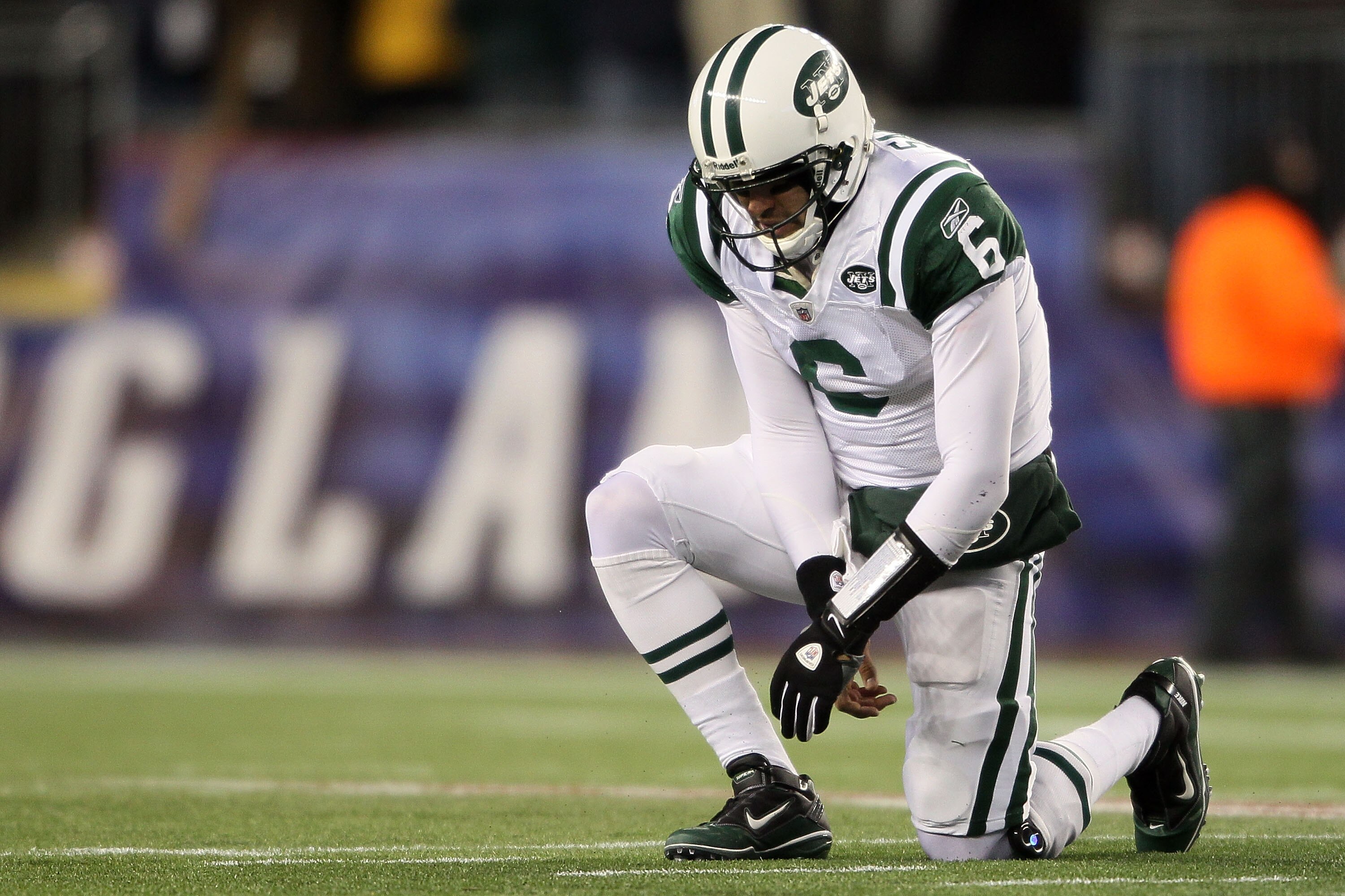 FOXBORO, MA - DECEMBER 06:  Mark Sanchez #6 of the New York Jets is slow to get up after he was knocked down on a play in the first quarter against the New England Patriots at Gillette Stadium on December 6, 2010 in Foxboro, Massachusetts.  (Photo by Elsa