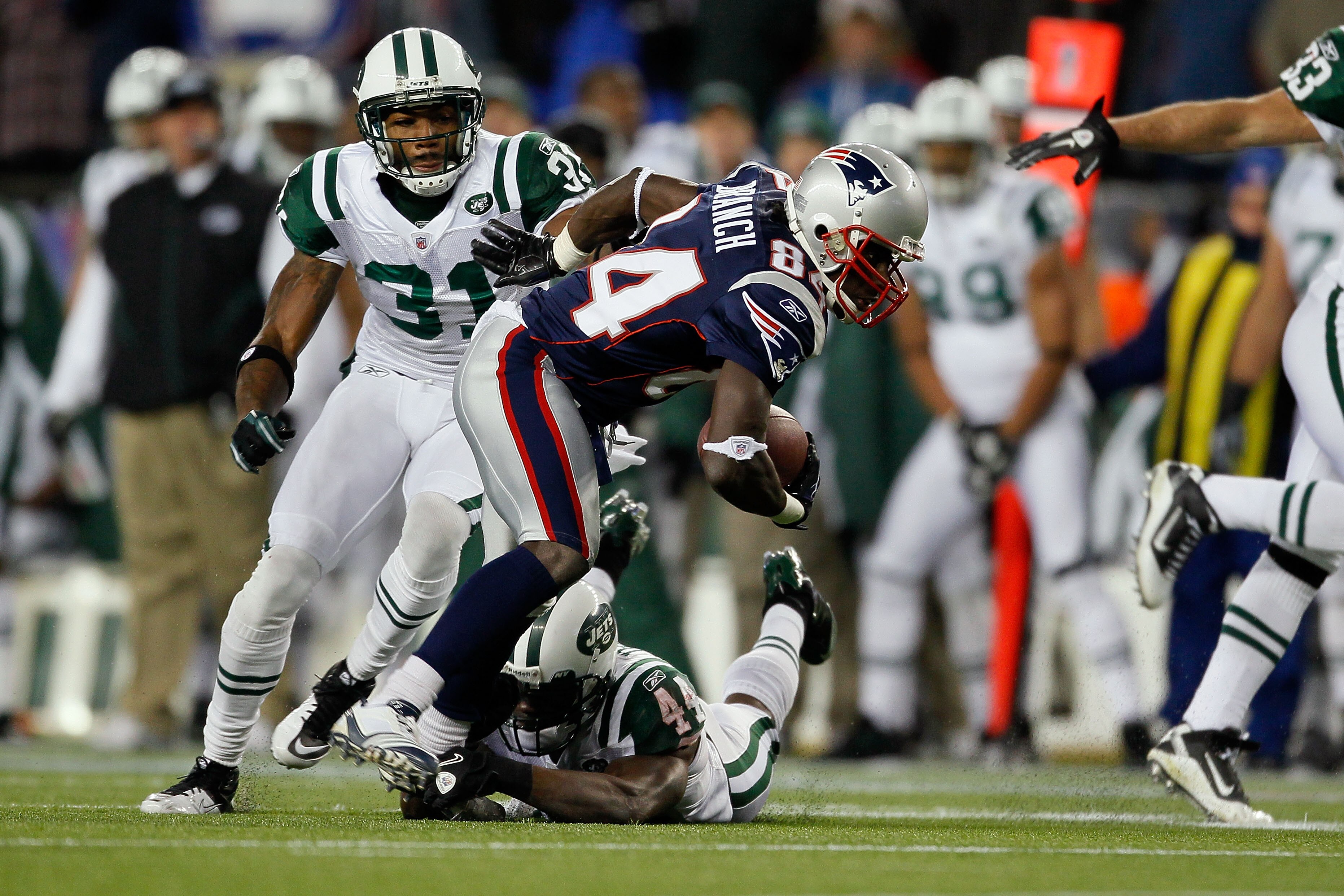 FOXBORO, MA - DECEMBER 06:  Deion Branch #84 of the New England Patriots scores on a 25-yard touchdown reception in the first quarter against James Ihedigbo #44 and Antonio Cromartie #31 of the New York Jets at Gillette Stadium on December 6, 2010 in Foxb