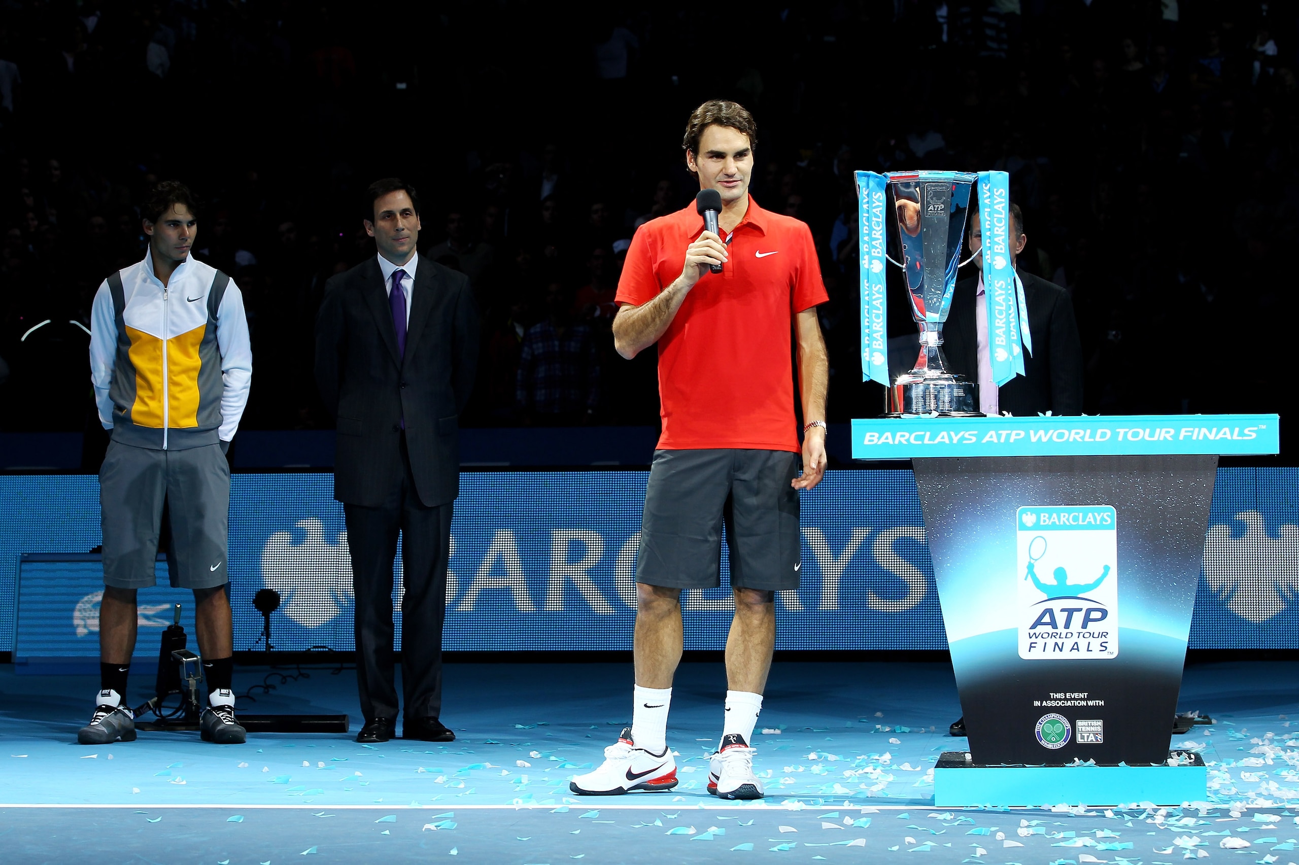 LONDON, ENGLAND - NOVEMBER 28:  Roger Federer of Switzerland talks, while Rafael Nadal of Spain (L) and  ATP Executive Chairman & President Adam Helfant (C) look on, after defeating Rafael Nadal of Spain in their men's final match during the ATP World Tou
