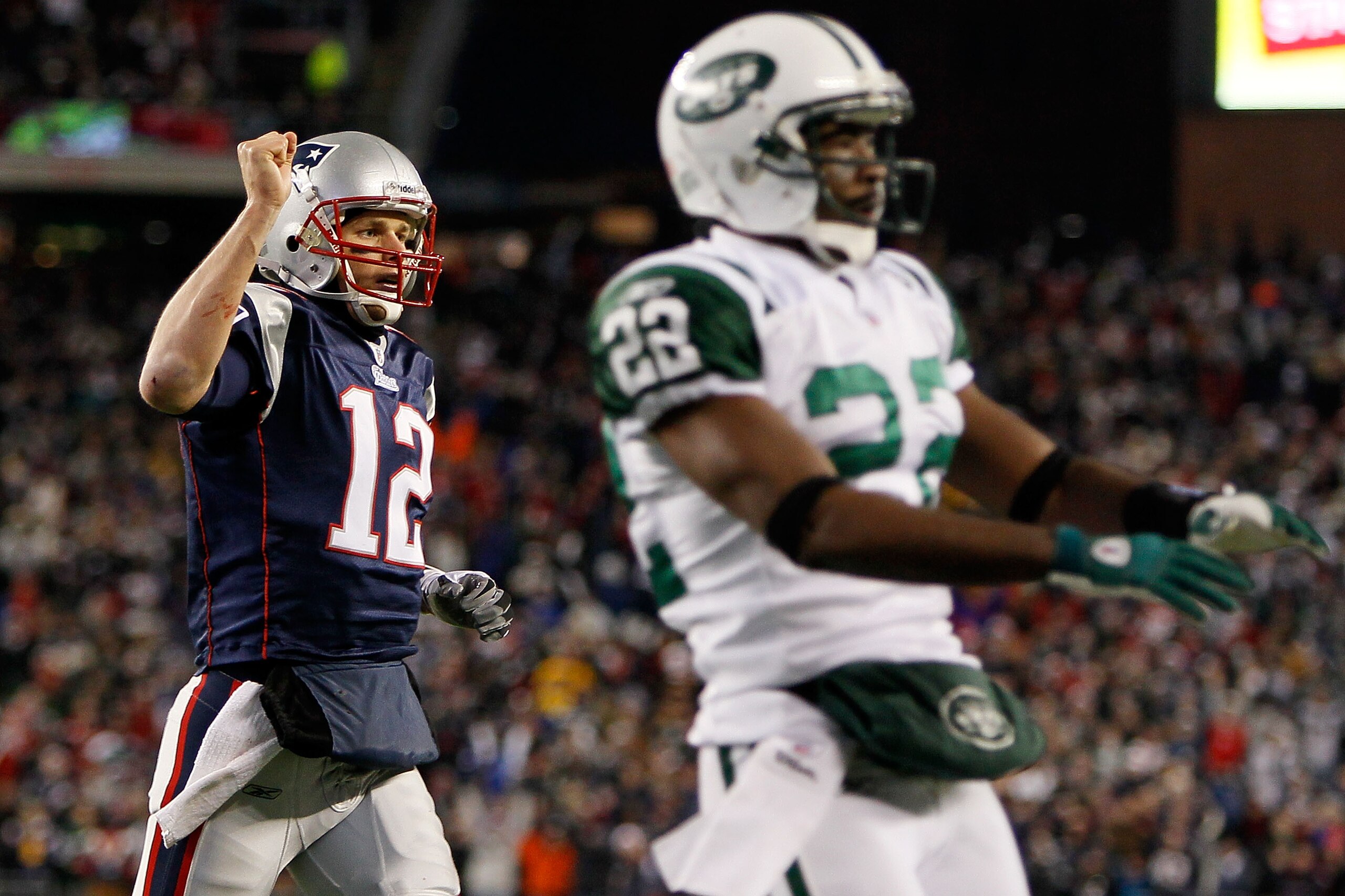 FOXBORO, MA - DECEMBER 06:  Tom Brady #12 of the New England Patriots reacts after Brandon Tate #19 scored a 4-yard touchdown ereception in the second quarter against Brodney Pool #22 (R) of the New York Jets at Gillette Stadium on December 6, 2010 in Fox