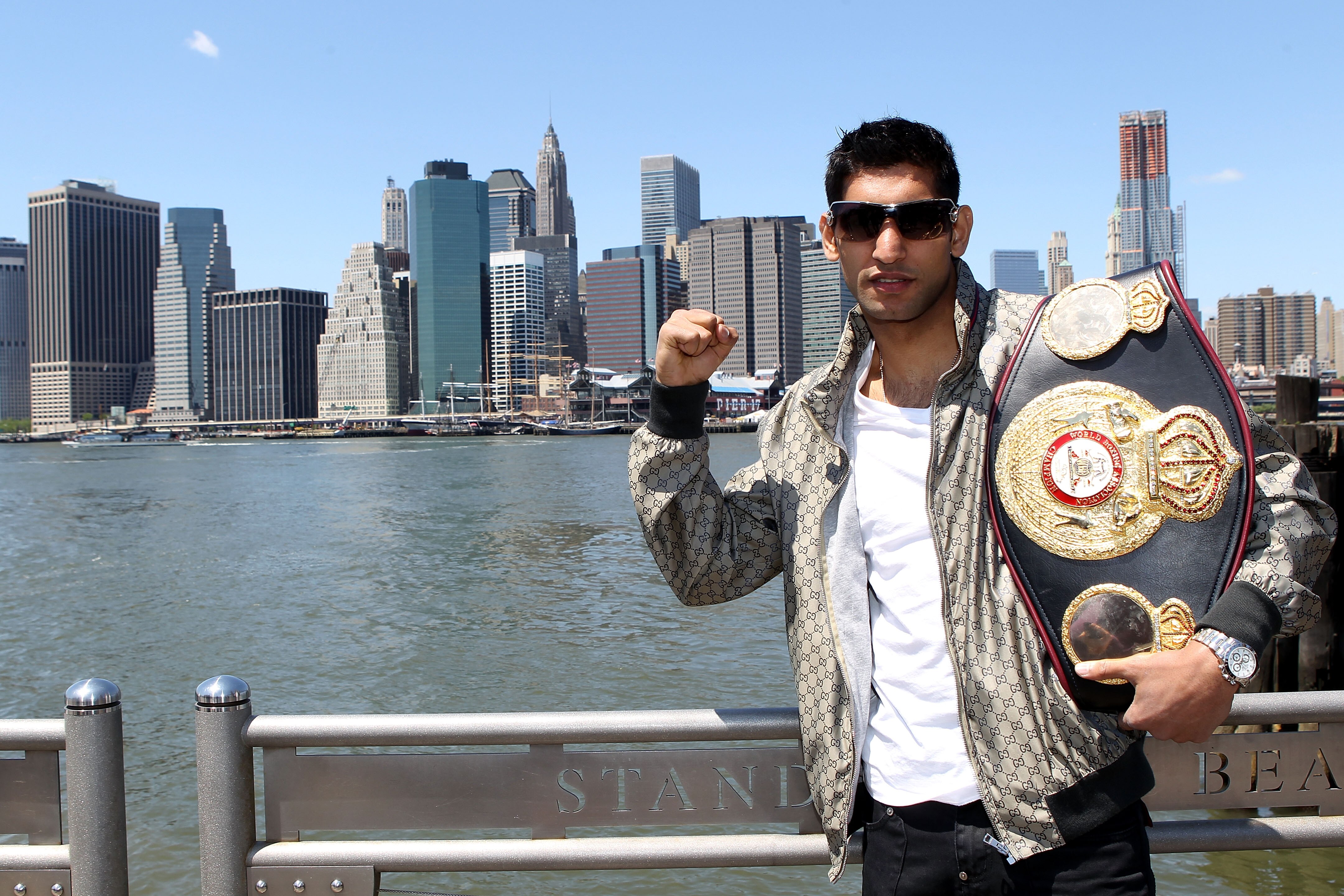 NEW YORK - MAY 10:  British boxer Amir Khan poses with the WBA World light welterweight championship belt by the Brooklyn Bridge on May 10, 2010 in the Brooklyn borough of New York City.  (Photo by John Gichigi/Getty Images)