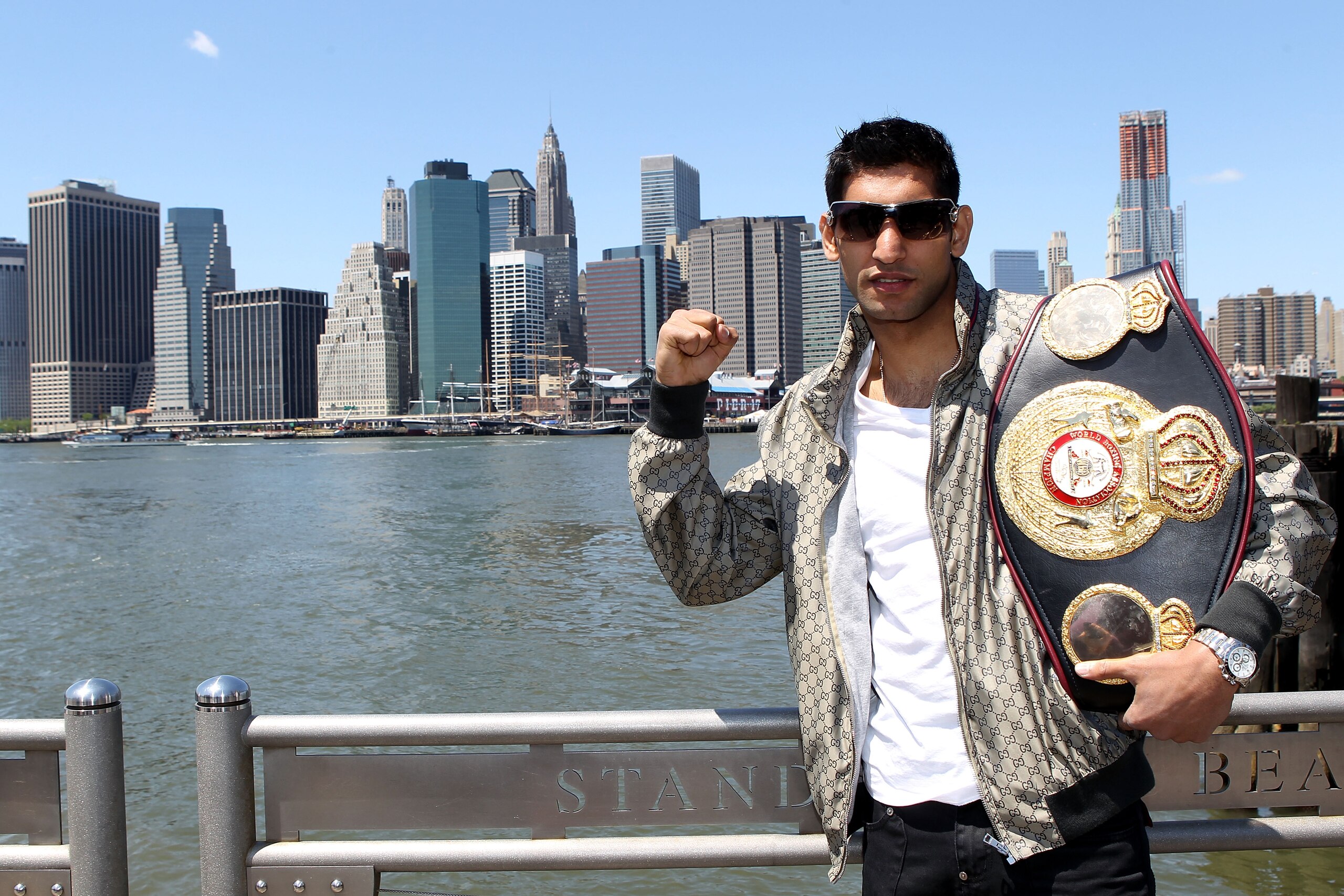 NEW YORK - MAY 10:  British boxer Amir Khan poses with the WBA World light welterweight championship belt by the Brooklyn Bridge on May 10, 2010 in the Brooklyn borough of New York City.  (Photo by John Gichigi/Getty Images)