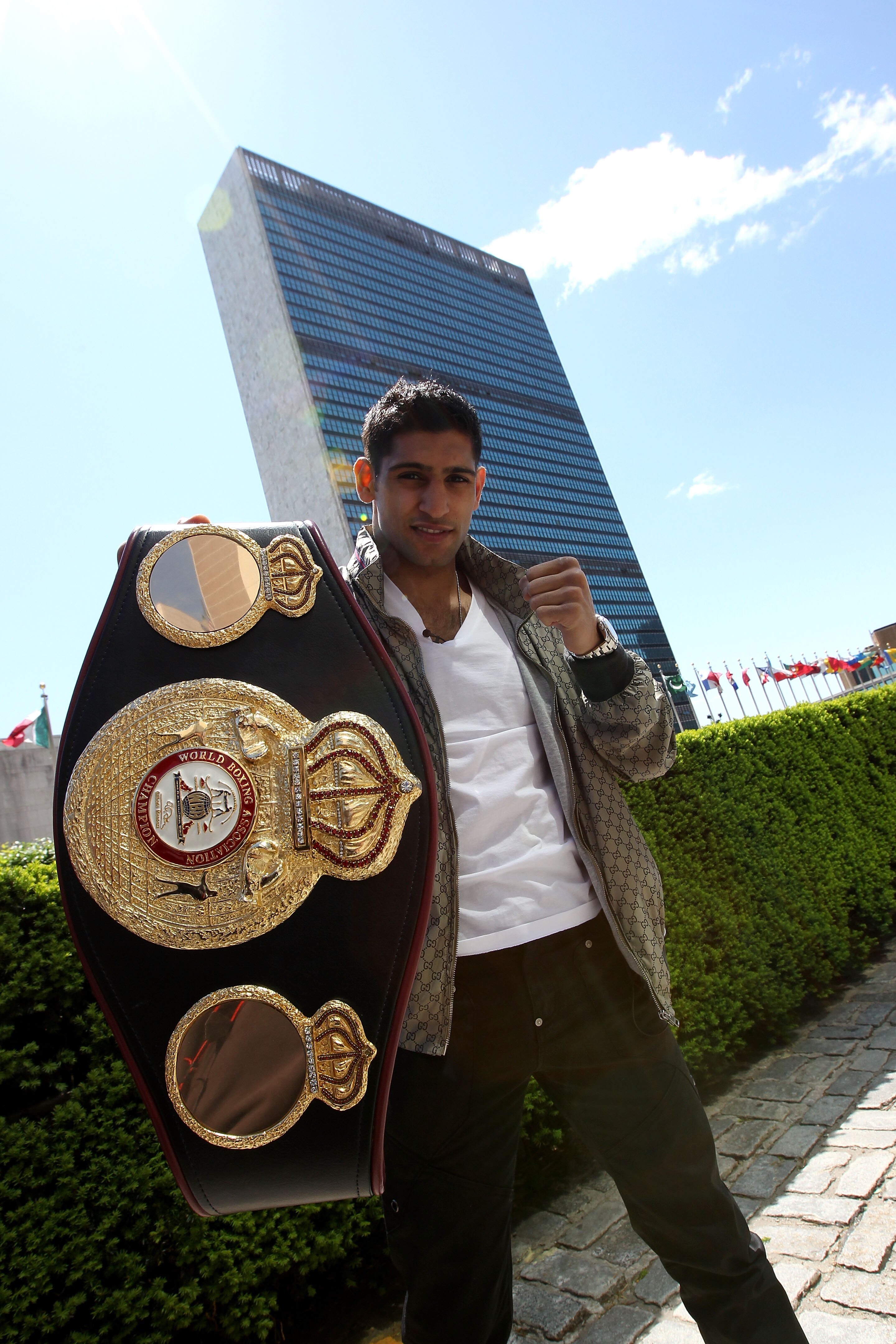 NEW YORK - MAY 10:  British boxer Amir Khan poses with the WBA World light welterweight championship belt in front of the United Nations headquarters on May 10, 2010 in New York City.  (Photo by John Gichigi/Getty Images)