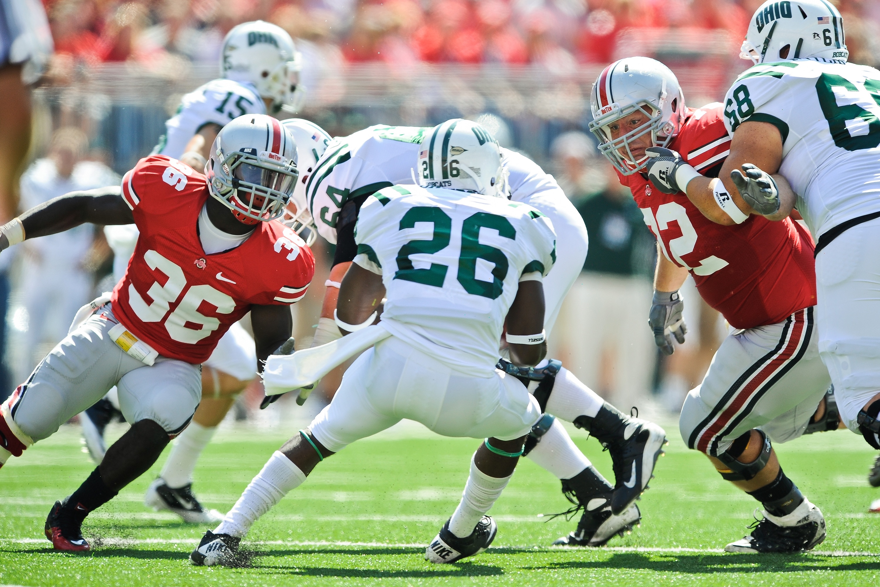 COLUMBUS, OH - SEPTEMBER 18:  Brian Rolle #36 of the Ohio State Buckeyes and Dexter Larimore #72 of the Ohio State Buckeyes close in on ballcarrier Vince Davidson #26 of the Ohio Bobcats at Ohio Stadium on September 18, 2010 in Columbus, Ohio.  (Photo by