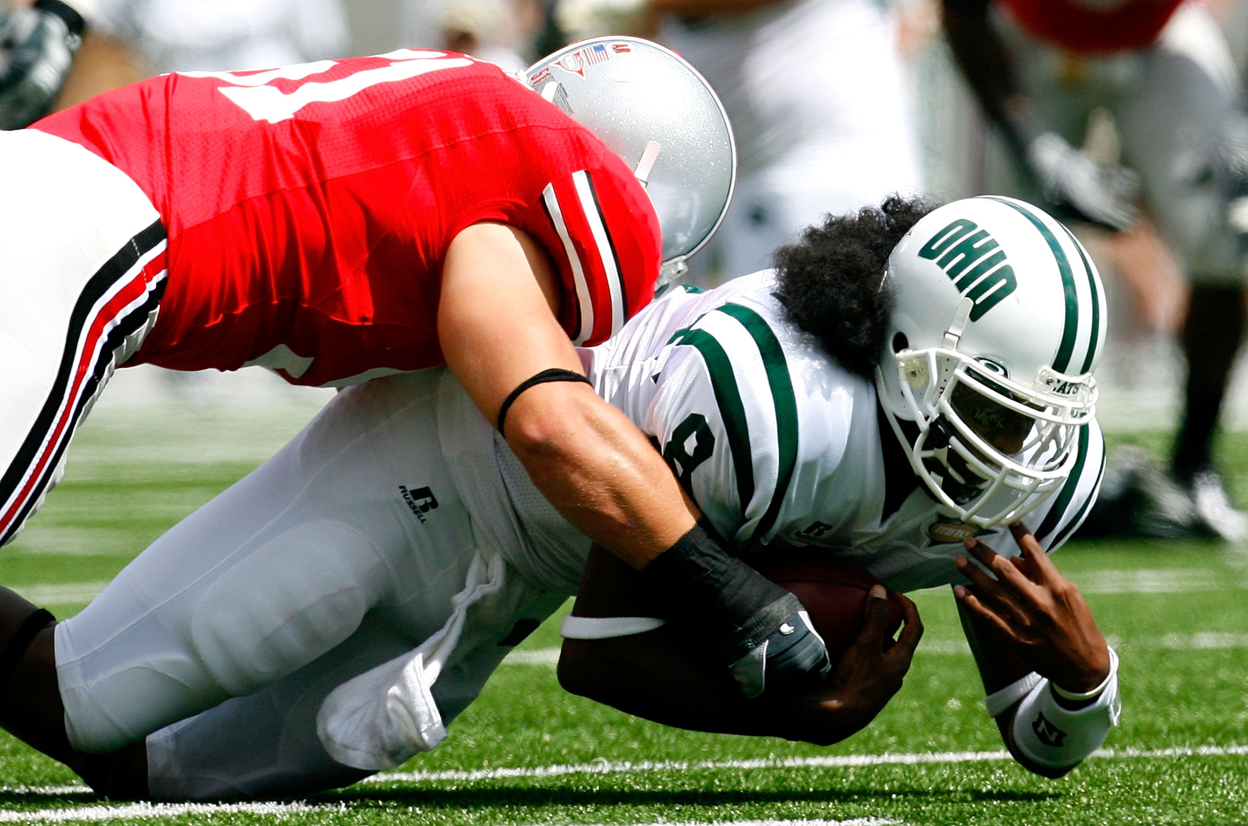 COLUMBUS, OH - SEPTEMBER 06: Quarterback Boo Jackson #8 of the Ohio Bobcats dives for more yardage against linebacker Ross Homan #51 of the Ohio State Buckeyes during the game at Ohio Stadium on September 6, 2008 in Columbus, Ohio. (Photo by Kevin C. Co COLUMBUS, OH - SEPTEMBER 06: Quarterback Boo Jackson #8 of the Ohio Bobcats dives for more yardage against linebacker Ross Homan #51 of the Ohio State Buckeyes during the game at Ohio Stadium on September 6, 2008 in Columbus, Ohio. (Photo by Kevin C. Co