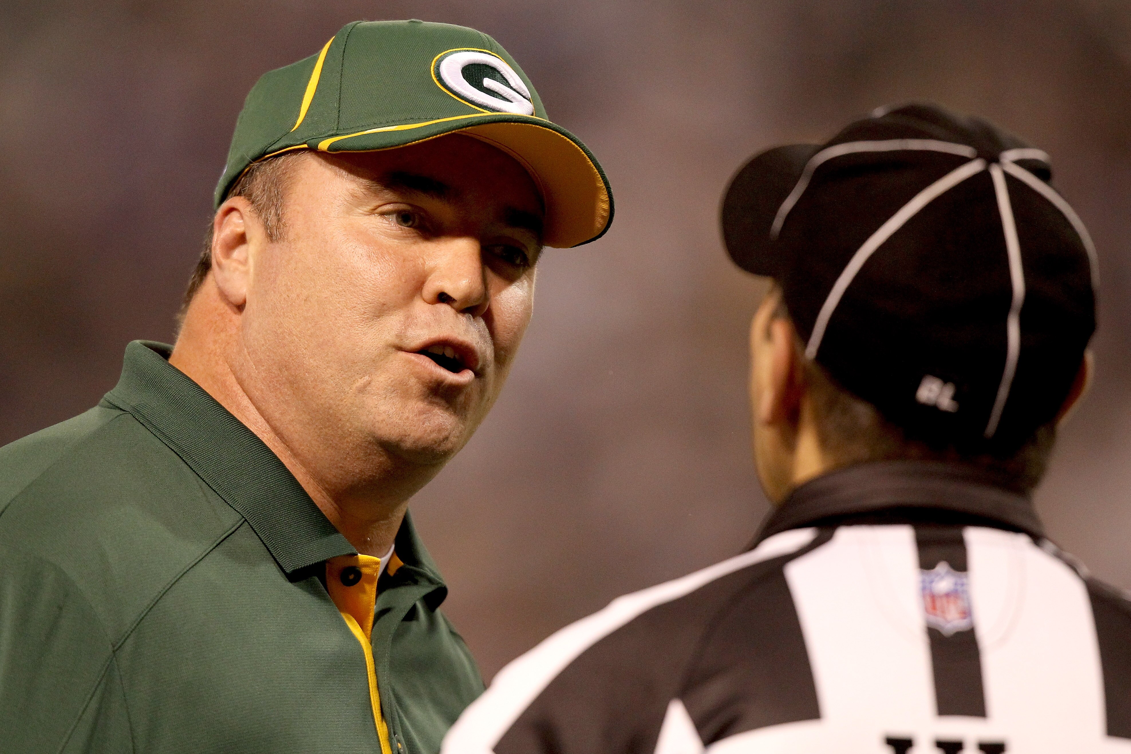 MINNEAPOLIS - NOVEMBER 21:  Head Coach Mike McCarthy of the Green Bay Packers discusses a call with Head Linesman Tony Veteri while playing the Minnesota Vikings at the Hubert H. Humphrey Metrodome on November 21, 2010 in Minneapolis, Minnesota.  (Photo b