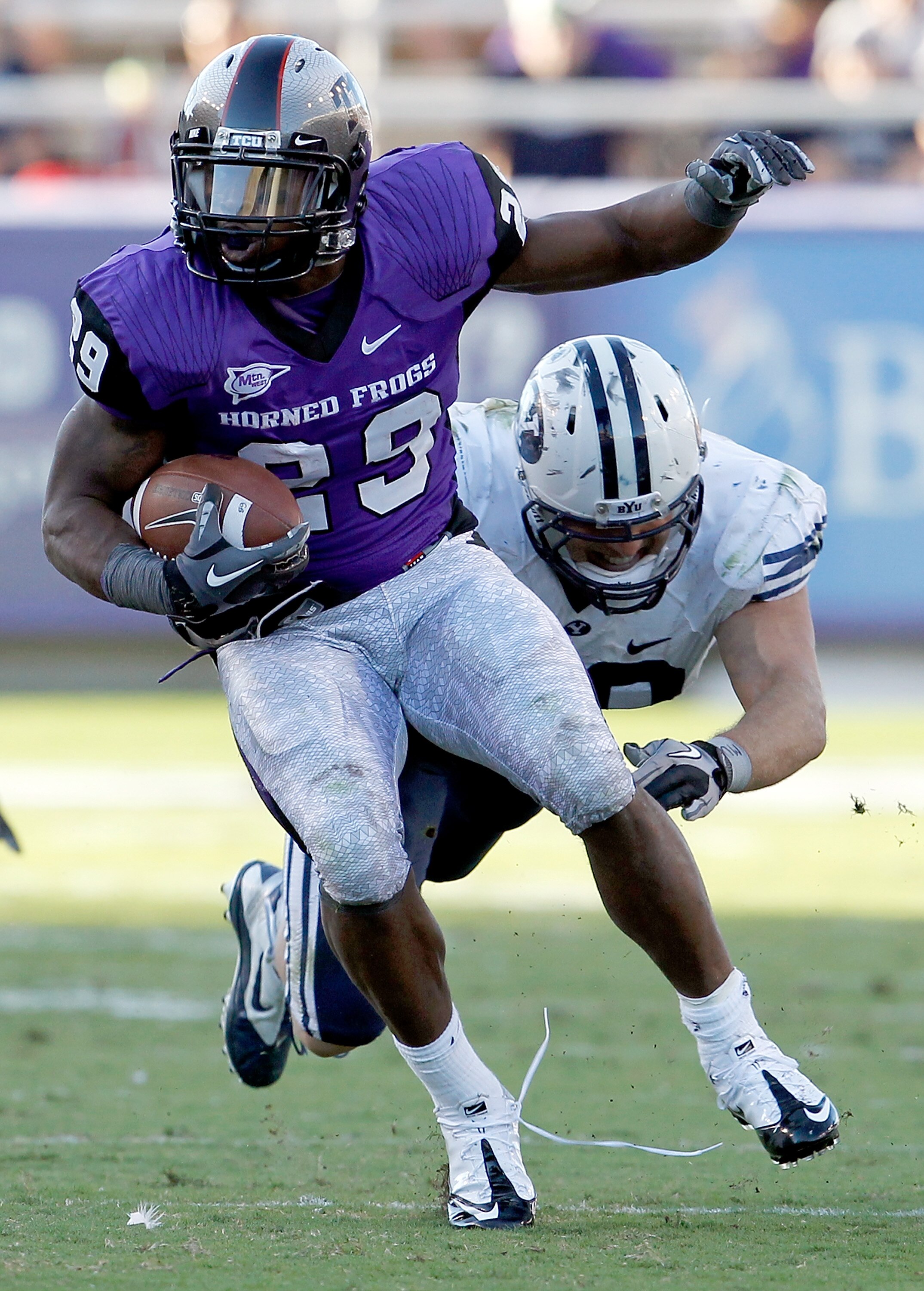 FORT WORTH, TX - OCTOBER 16:  Tailback Matthew Tucker #29 of the TCU Horned Frogs carries the ball against linebacker Jadon Wagner #49 of the BYU Cougars at Amon G. Carter Stadium on October 16, 2010 in Fort Worth, Texas.  TCU beat BYU 31-3.  (Photo by To