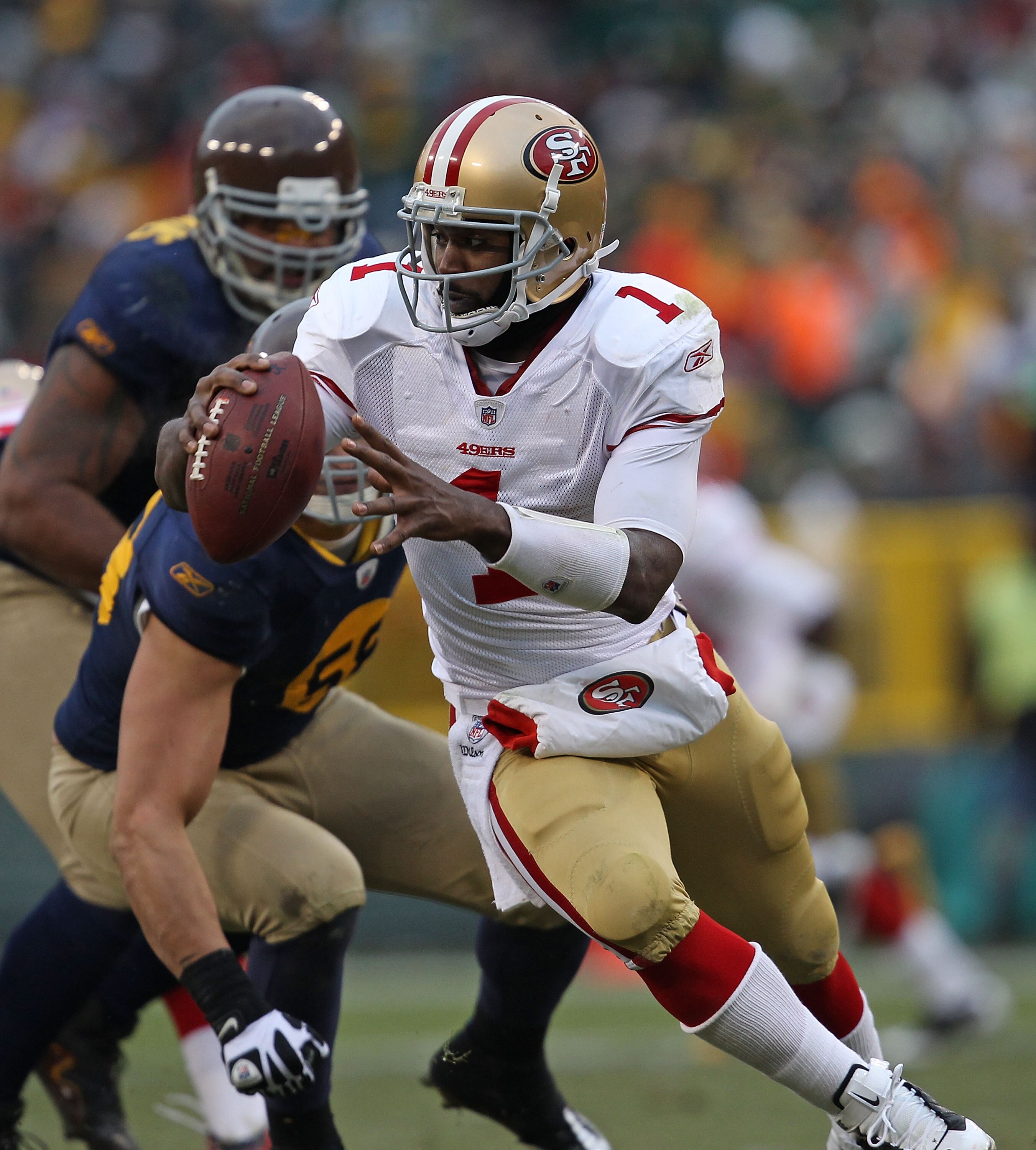 GREEN BAY, WI - DECEMBER 05: Troy Smith #1 of the San Francisco 49ers rolls out against the Green Bay Packers at Lambeau Field on December 5, 2010 in Green Bay, Wisconsin. The Packers defeated the 49ers 34-16. (Photo by Jonathan Daniel/Getty Images)