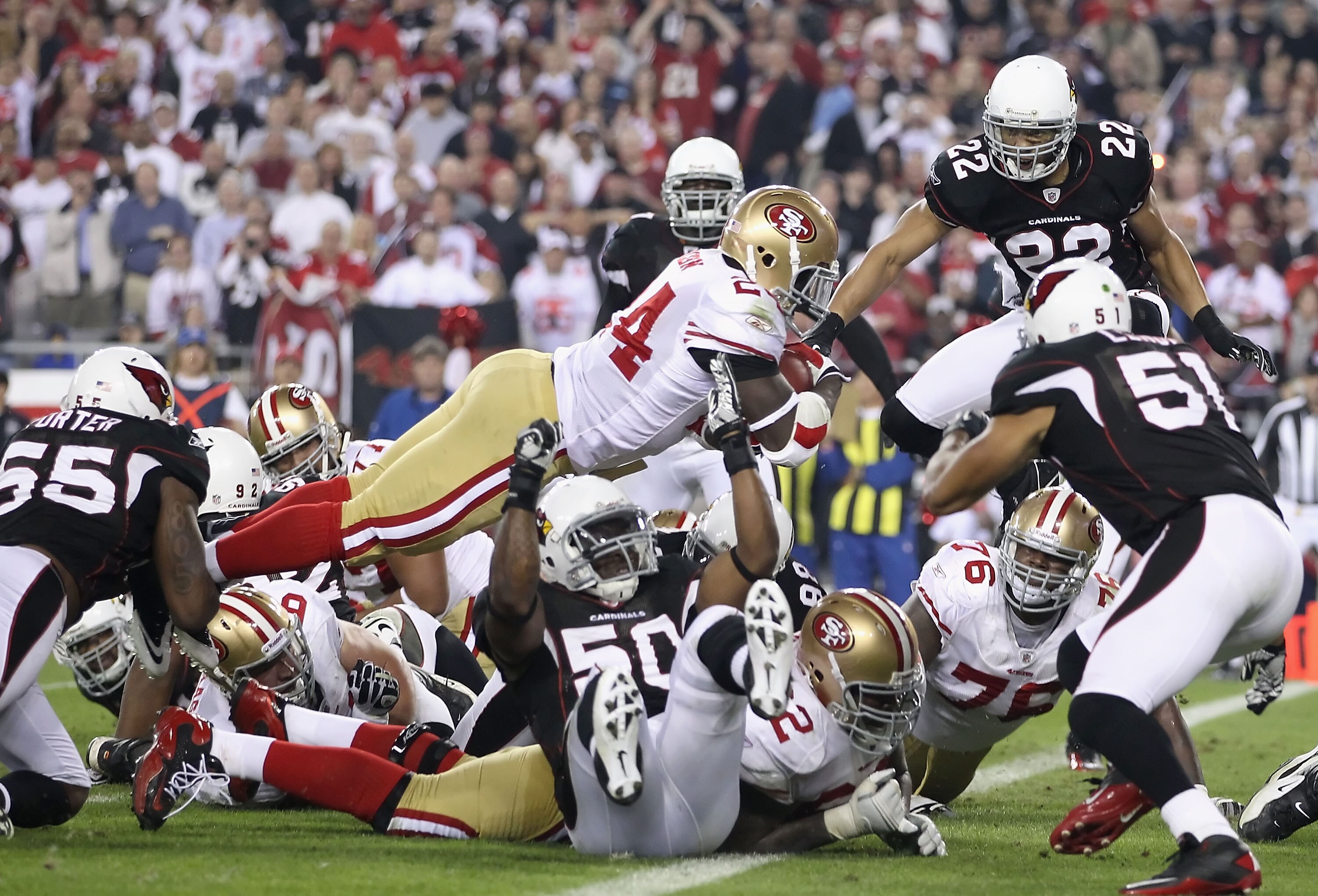 GLENDALE, AZ - NOVEMBER 29:  Runningback Anthony Dixon #1 of the San Francisco 49ers dives into the endzone to score on a 1 yard rushing touchdown against the Arizona Cardinals during the first quarter of the NFL game at the University of Phoenix Stadium
