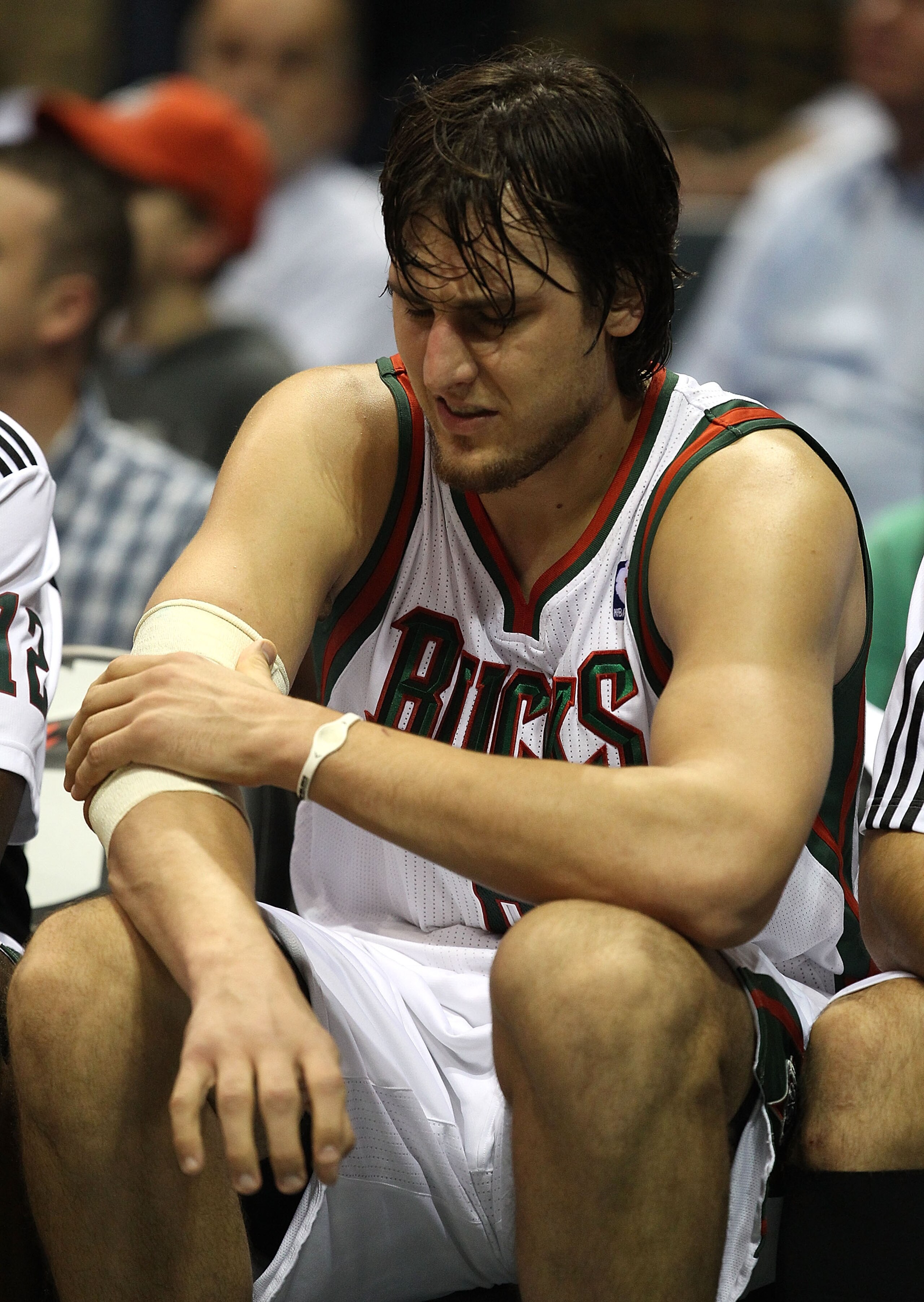MILWAUKEE - NOVEMBER 16: Andrew Bogut #6 of the Milwaukee Bucks grabs his elbow as he sits on the bench near the end of a game against the Los Angeles Lakers at the Bradley Center on November 16, 2010 in Milwaukee, Wisconsin. The Lakers defeated the Bucks