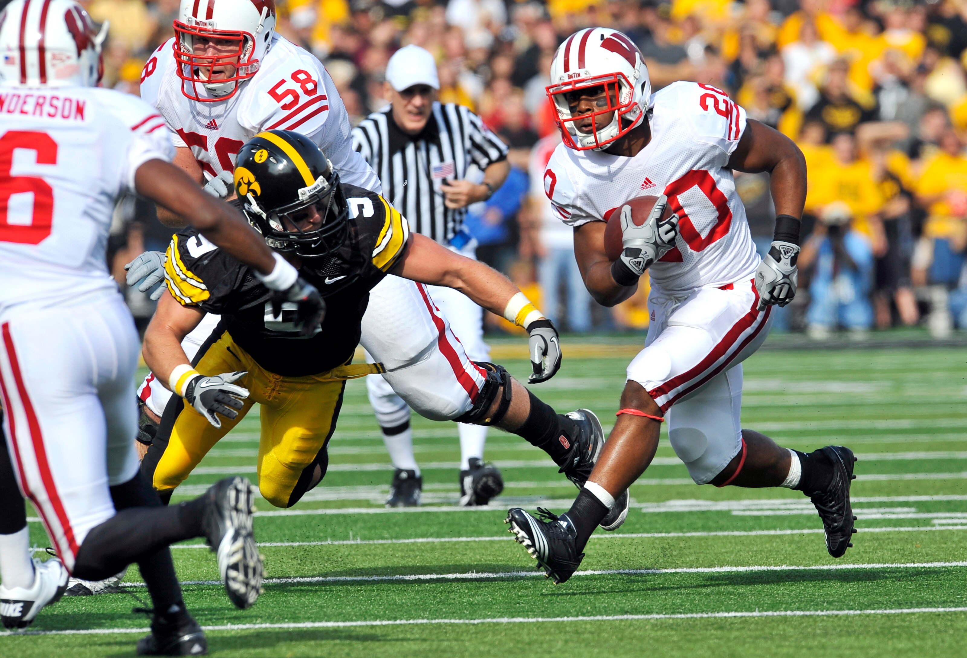 IOWA CITY, IA - OCTOBER 23: Defensive back Tyler Sash #9 of the University of Iowa Hawkeyes closes in on running back James White #20 of the Wisconsin Badgers as he rushes for yards during the first half of play at Kinnick Stadium on October 23, 2010 in I