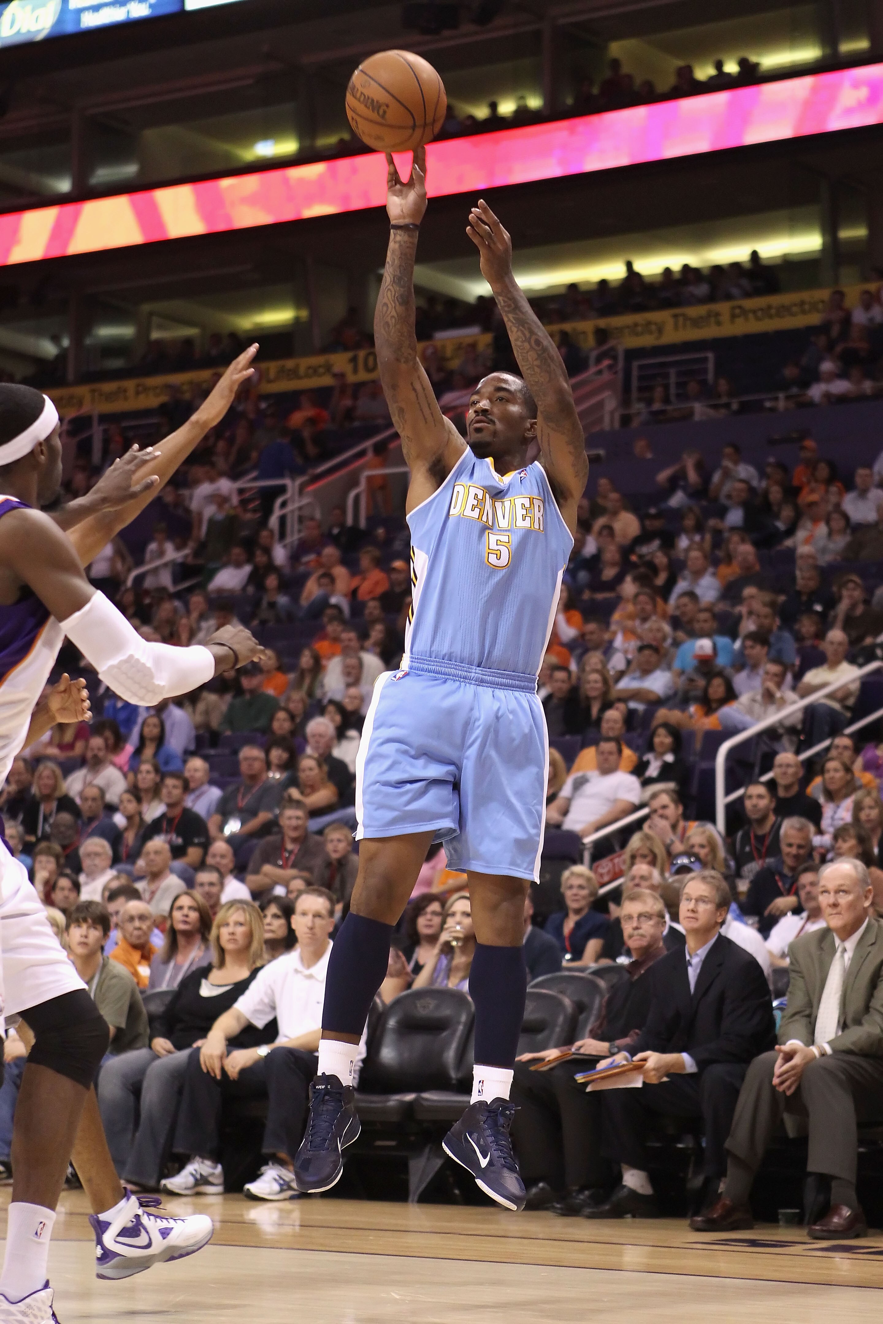 PHOENIX - OCTOBER 22:  J.R. Smith #5 of the Denver Nuggets puts up a three point shot against the Phoenix Suns during the preseason NBA game at US Airways Center on October 22, 2010 in Phoenix, Arizona. NOTE TO USER: User expressly acknowledges and agrees