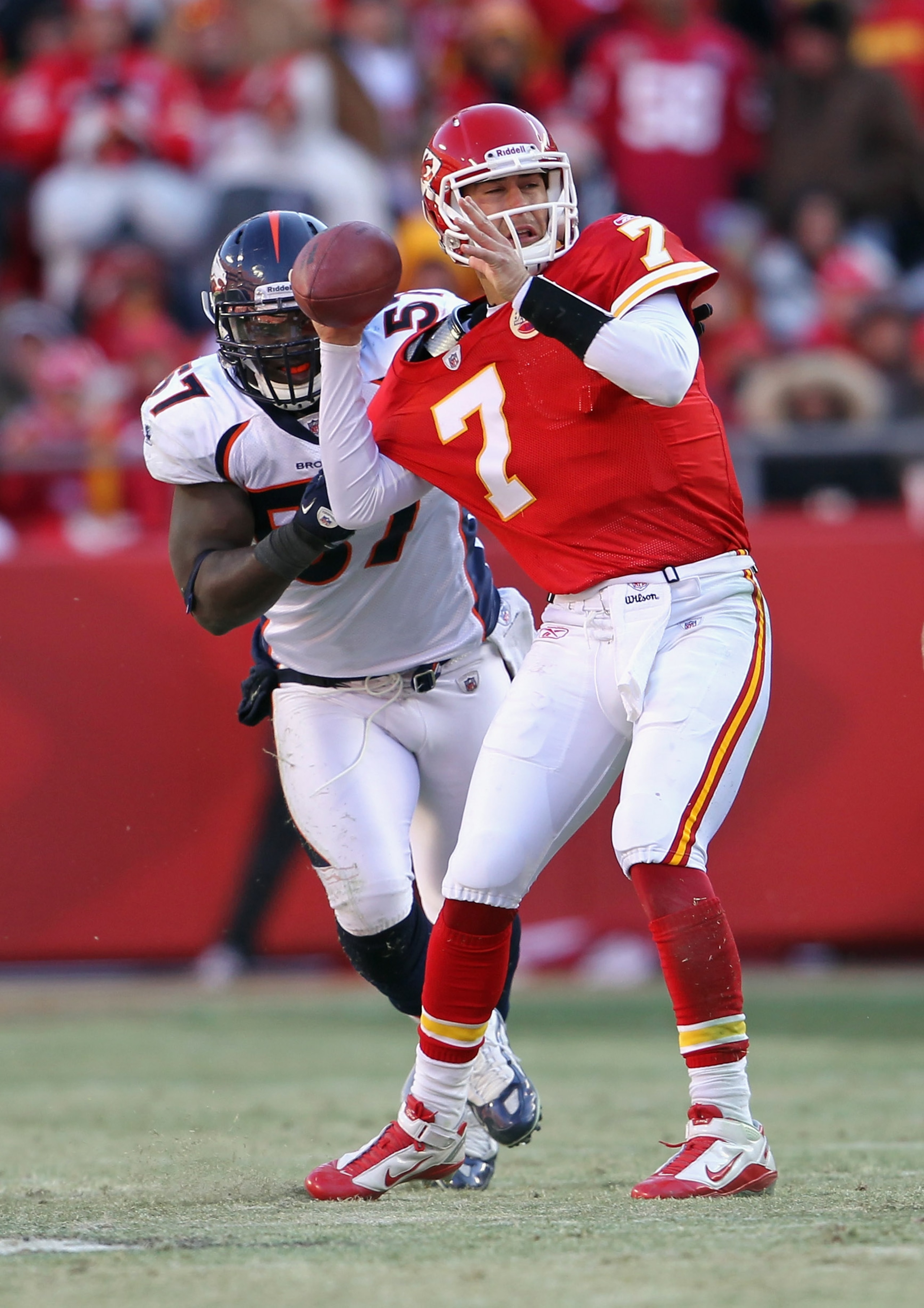 KANSAS CITY, MO - DECEMBER 05:  Quarterback Matt Cassel #7 of the Kansas City Chiefs is pressured by Mario Haggan #57 of the Denver Broncos during the game on December 5, 2010 at Arrowhead Stadium in Kansas City, Missouri.  (Photo by Jamie Squire/Getty Im