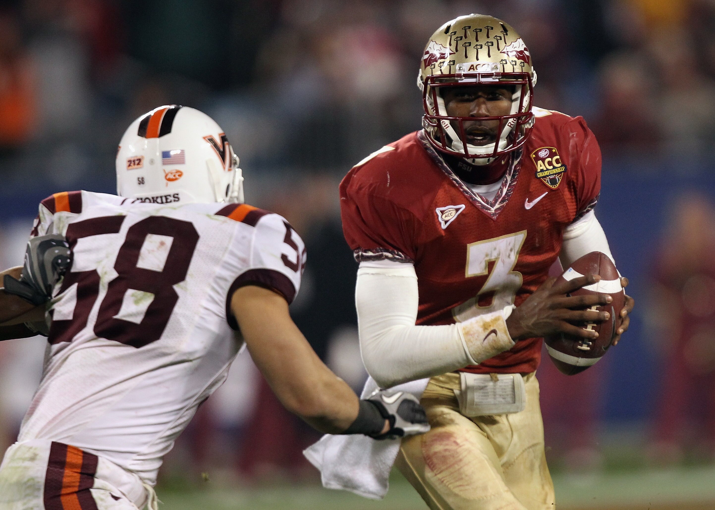 CHARLOTTE, NC - DECEMBER 04:  EJ Manuel #3 of the Florida State Seminoles runs away from Jack Tyler #58 of the Virginia Tech Hokies during their game at Bank of America Stadium on December 4, 2010 in Charlotte, North Carolina.  (Photo by Streeter Lecka/Ge