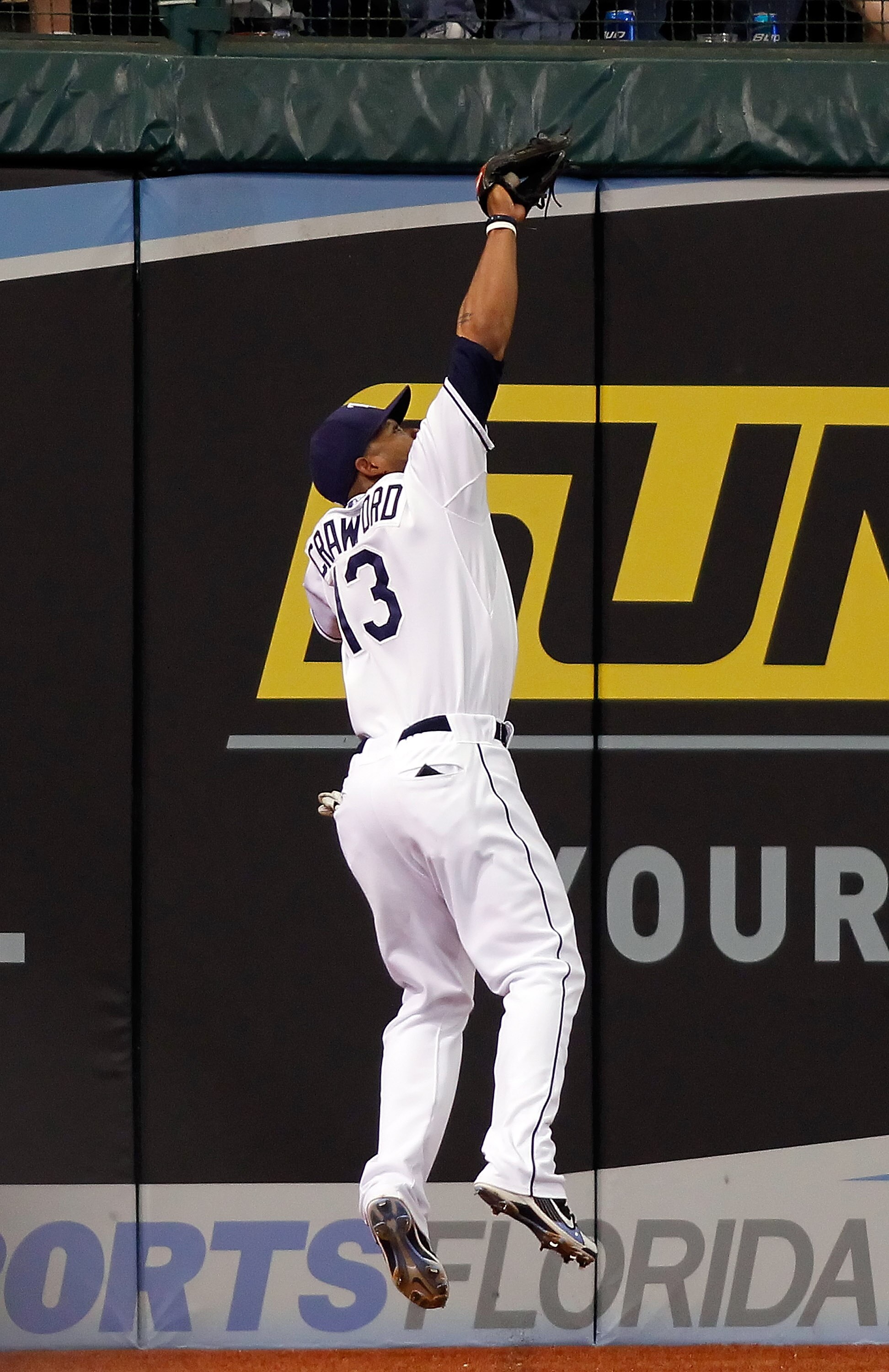 ST. PETERSBURG - MAY 15:  Outfielder Carl Crawford #13 of the Tampa Bay Rays catches a fly ball against the Seattle Mariners during the game at Tropicana Field on May 15, 2010 in St. Petersburg, Florida.  (Photo by J. Meric/Getty Images)