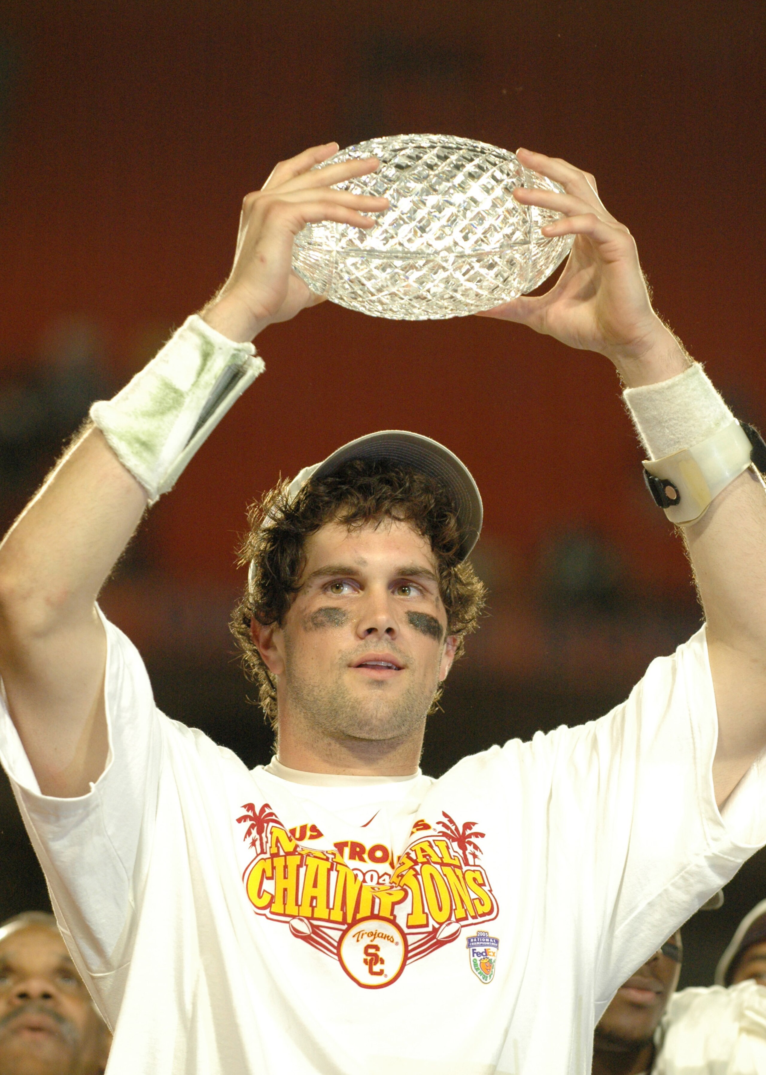 USC quarterback Matt Leinart holds up part of the National Championship Trophy during the FedEx Orange Bowl National Championship at Pro Player Stadium in Miami, Florida on January 4, 2005. USC beat Oklahoma 55-19. (Photo by A. Messerschmidt/Getty Images)