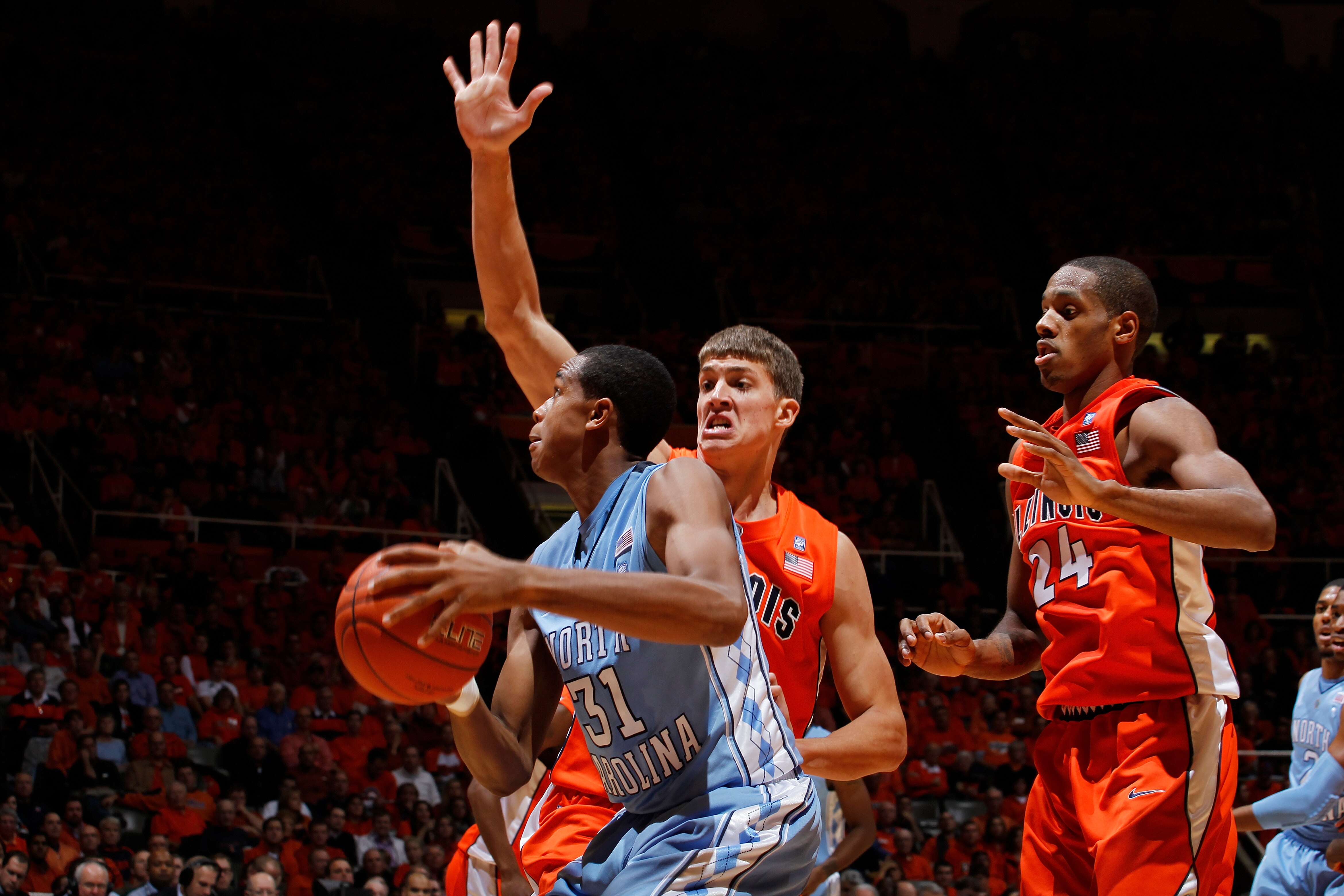 CHAMPAIGN, IL - NOVEMBER 30: Meyers Leonard #12 and Mike Davis #24 of the Illinois Fighting Illini defend against John Henson #31 of the North Carolina Tar Heels during the 2010 ACC/Big Ten Challenge at Assembly Hall on November 30, 2010 in Champaign, Ill
