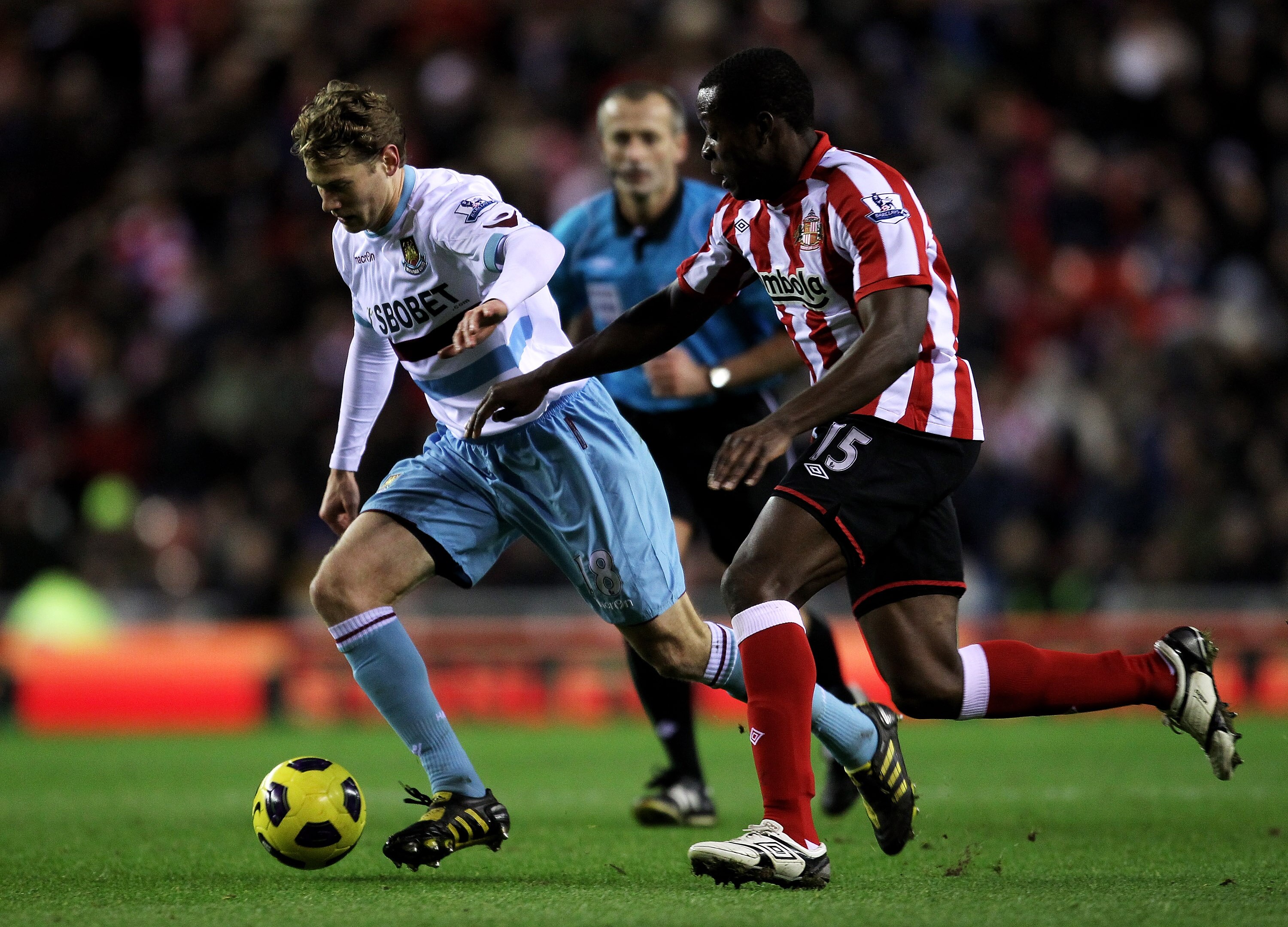 SUNDERLAND, ENGLAND - DECEMBER 05:  Nedum Onuoha of Sunderland competes for the ball with Jonathan Spector of West Ham United during the Barclays Premier League match between Sunderland and West Ham United at the Stadium of Light on December 5, 2010 in Su