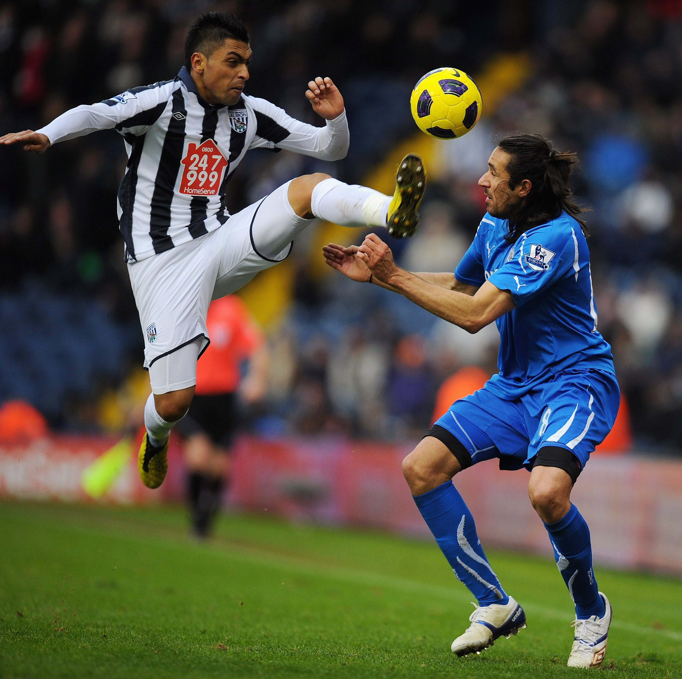 WEST BROMWICH, ENGLAND - DECEMBER 05:  Jonas Gutierrez of Newcastle United is challenged by Gonzalo Jara of West Bromwich Albion during the Barclays Premier League match between West Bromwich Albion and Newcastle United at The Hawthorns on December 5, 201