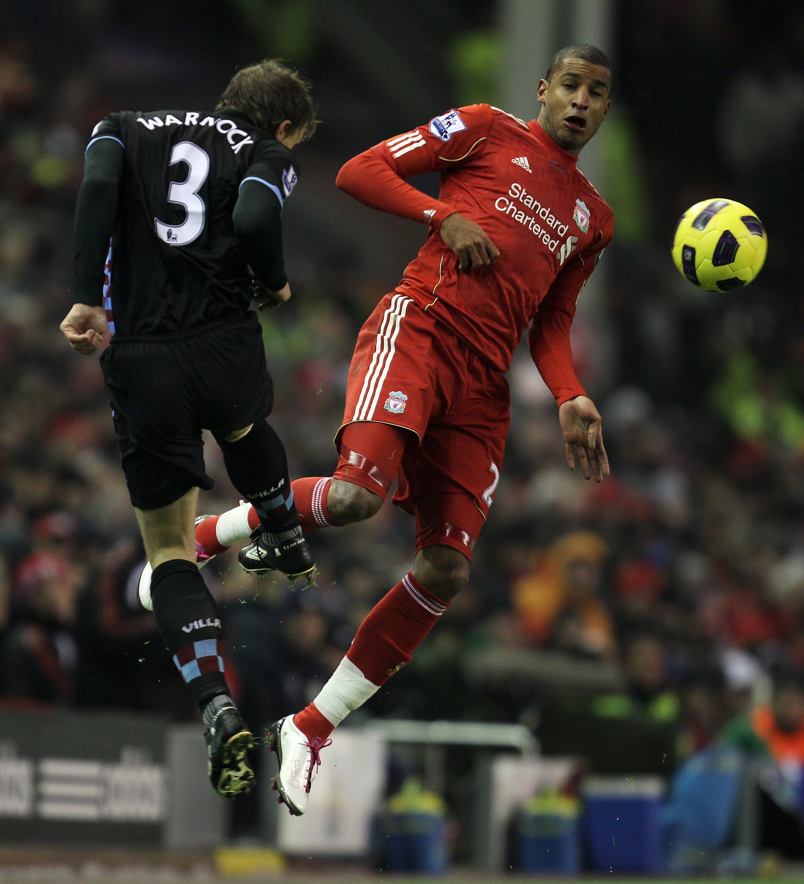 LIVERPOOL, ENGLAND - DECEMBER 06:  Stephen Warnock of Aston Villa competes with David Ngog of Liverpool during the Barclays Premier League match between Liverpool and Aston Villa at Anfield on December 6, 2010 in Liverpool, England. (Photo by Mark Thompso