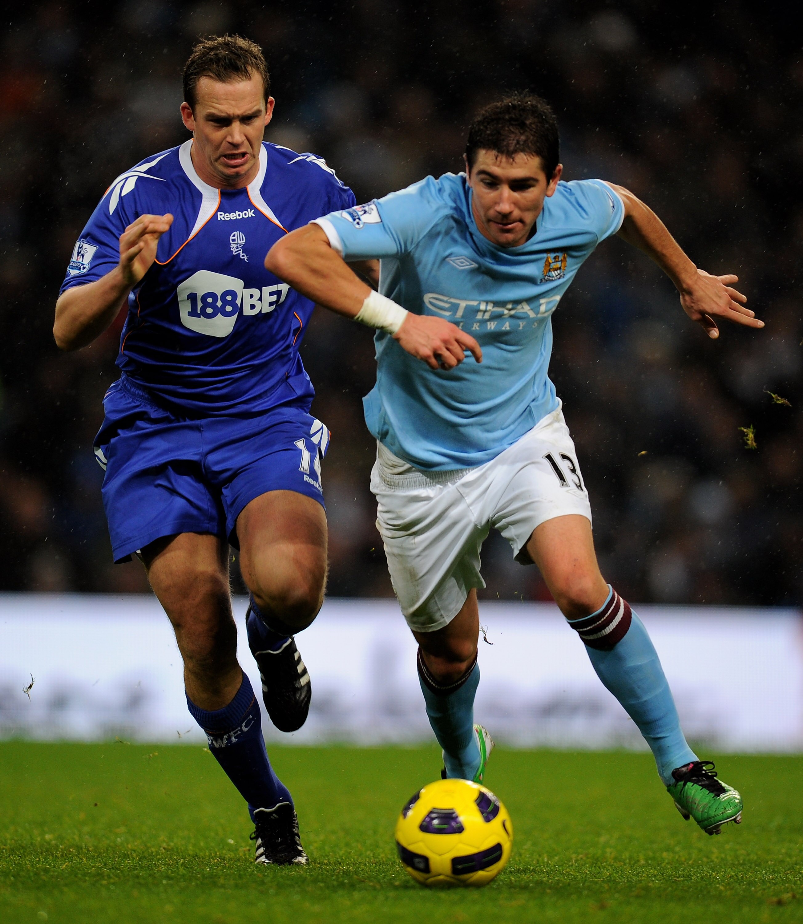 MANCHESTER, UNITED KINGDOM - DECEMBER 04:   Aleksandar Kolarov of Manchester City competes with Kevin Davies of Bolton Wanderers during the Barclays Premier League match between Manchester City and Bolton Wanderers at the City of Manchester Stadium on Dec