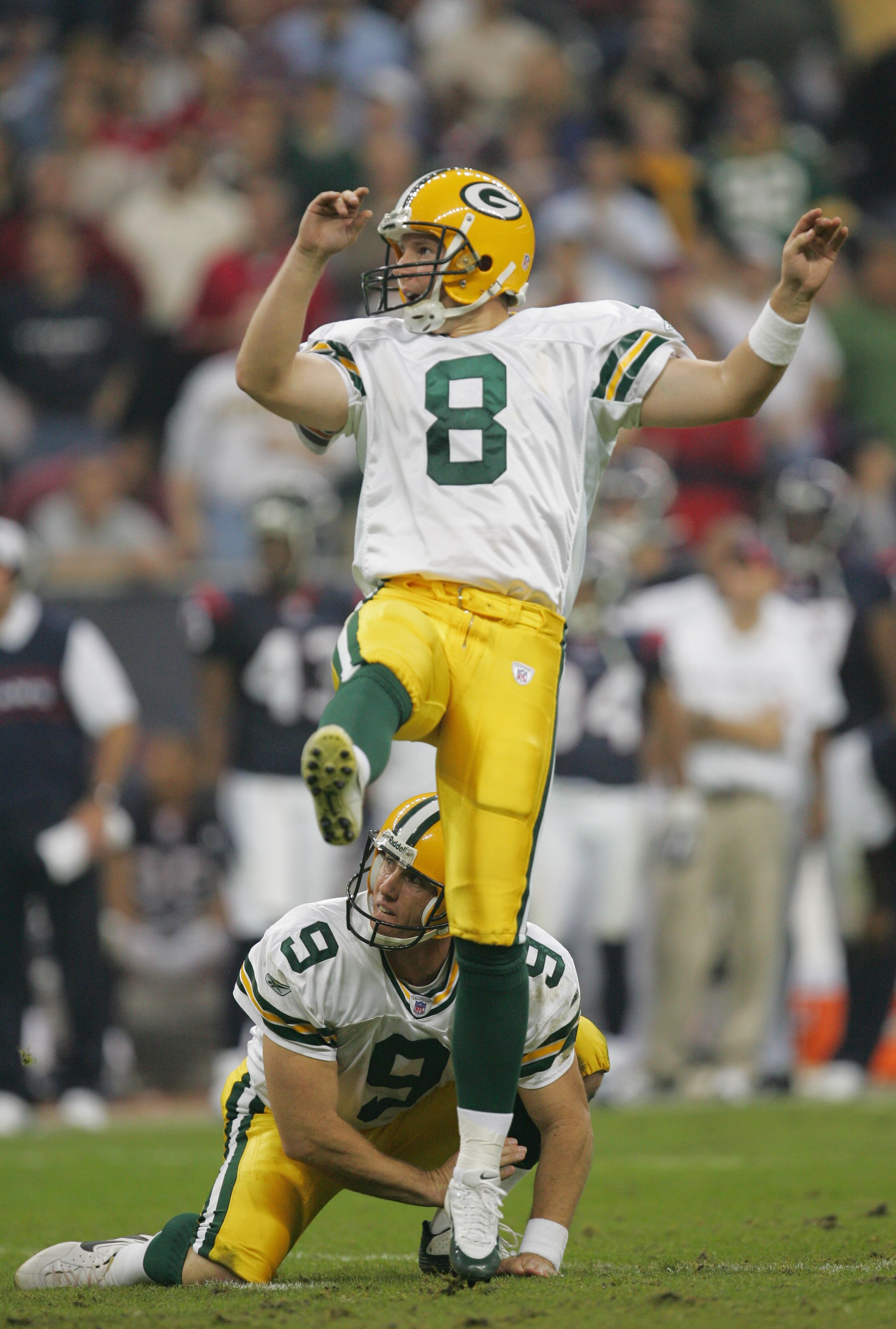 HOUSTON - NOVEMBER 21:  Kicker Ryan Longwell #8 of the Green Bay Packers completes a kick attempt against the Houston Texans as punter Bryan Barker #9 watches on November 21, 2004 at Reliant Stadium in Houston, Texas.   The Packers defeated the Texans 16-