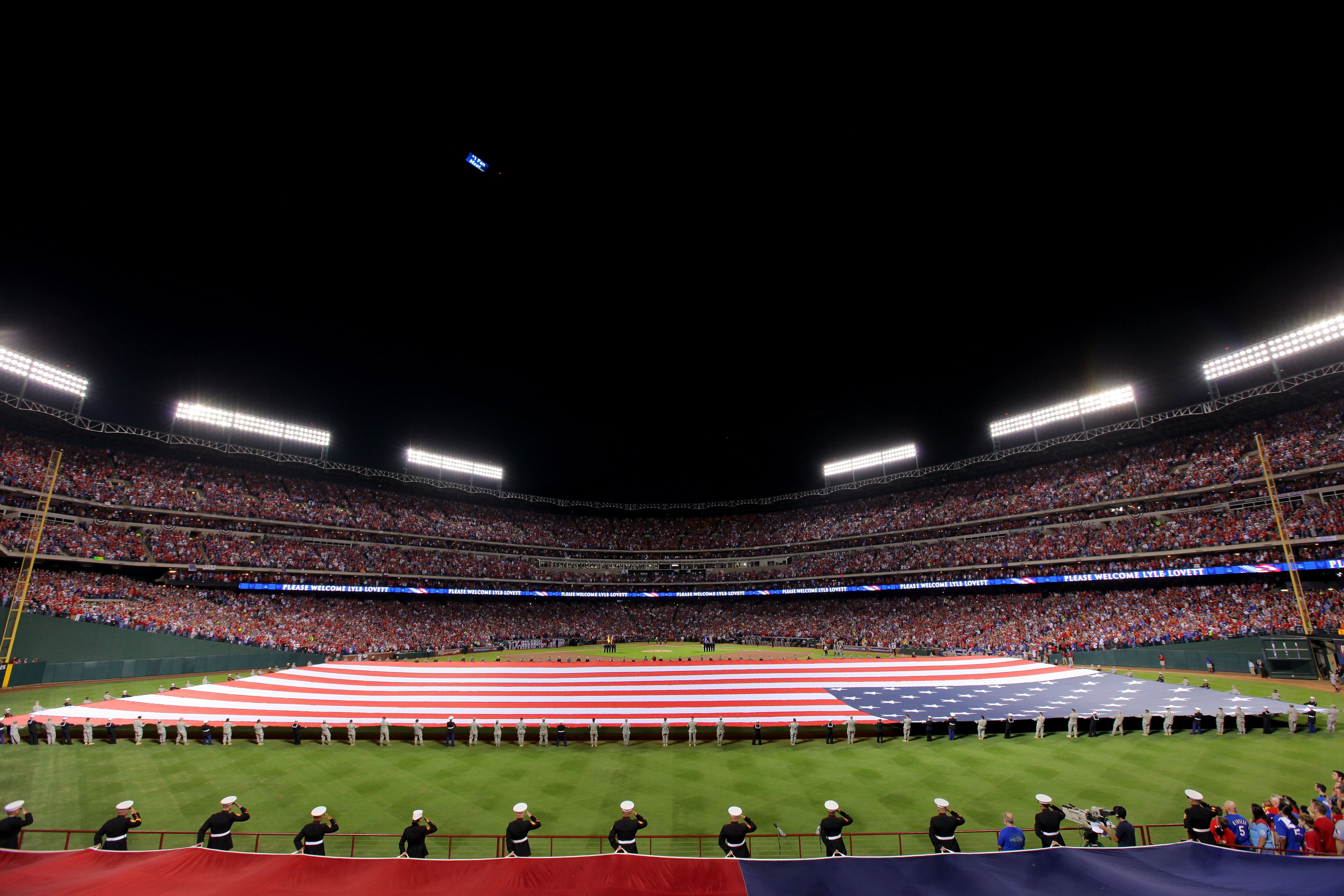 ARLINGTON, TX - OCTOBER 31:  A general view of the stadium is seen as an American Flag and Texas state flag are stretched across the field during pregame festivities before Game Four between the the Texas Rangers and the San Francisco Giants during the 20