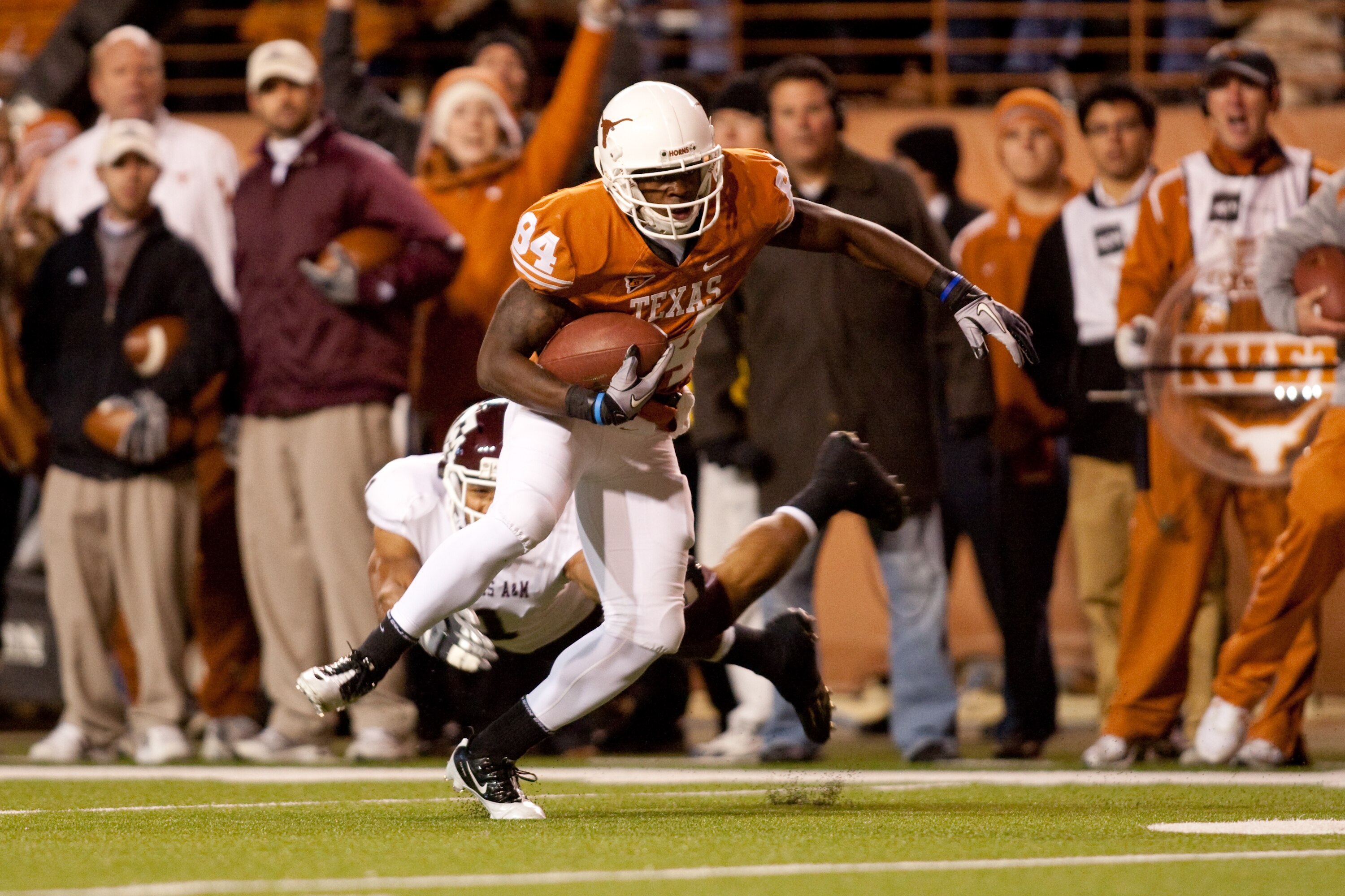 AUSTIN, TX - NOVEMBER 25:  University of Texas wide receiver Marquise Goodwin #84 eldues Texas A&M safety Trent Hunter #1 during a touchdown reception in the first half at Darrell K. Royal-Texas Memorial Stadium on November 25, 2010 in Austin, Texas. (Pho