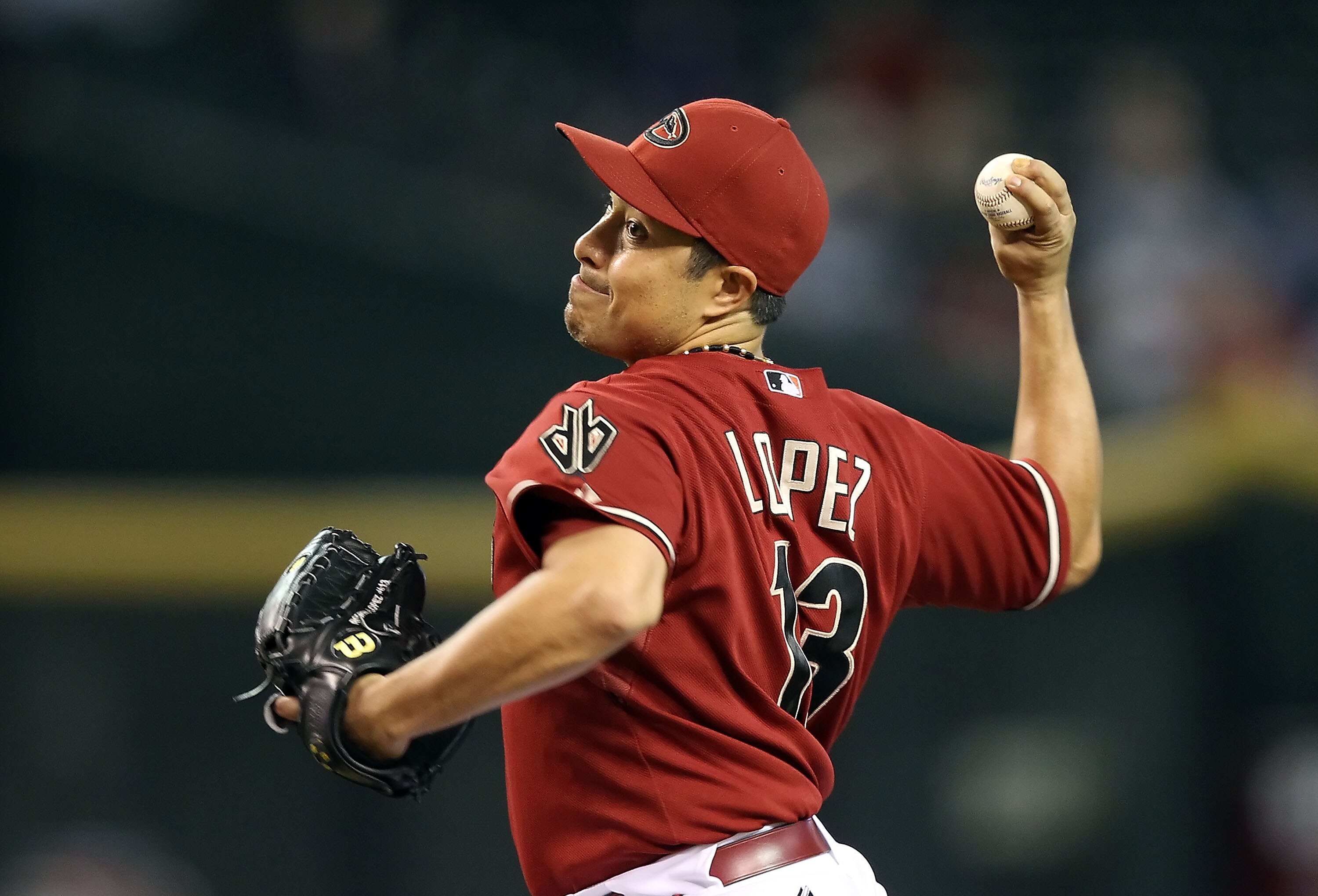 PHOENIX - AUGUST 18:  Starting pitcher Rodrigo Lopez #13 of the Arizona Diamondbacks pitches against the Cincinnati Reds during the Major League Baseball game at Chase Field on August 18, 2010 in Phoenix, Arizona.  The Reds defeated the Diamondbacks 11-7.