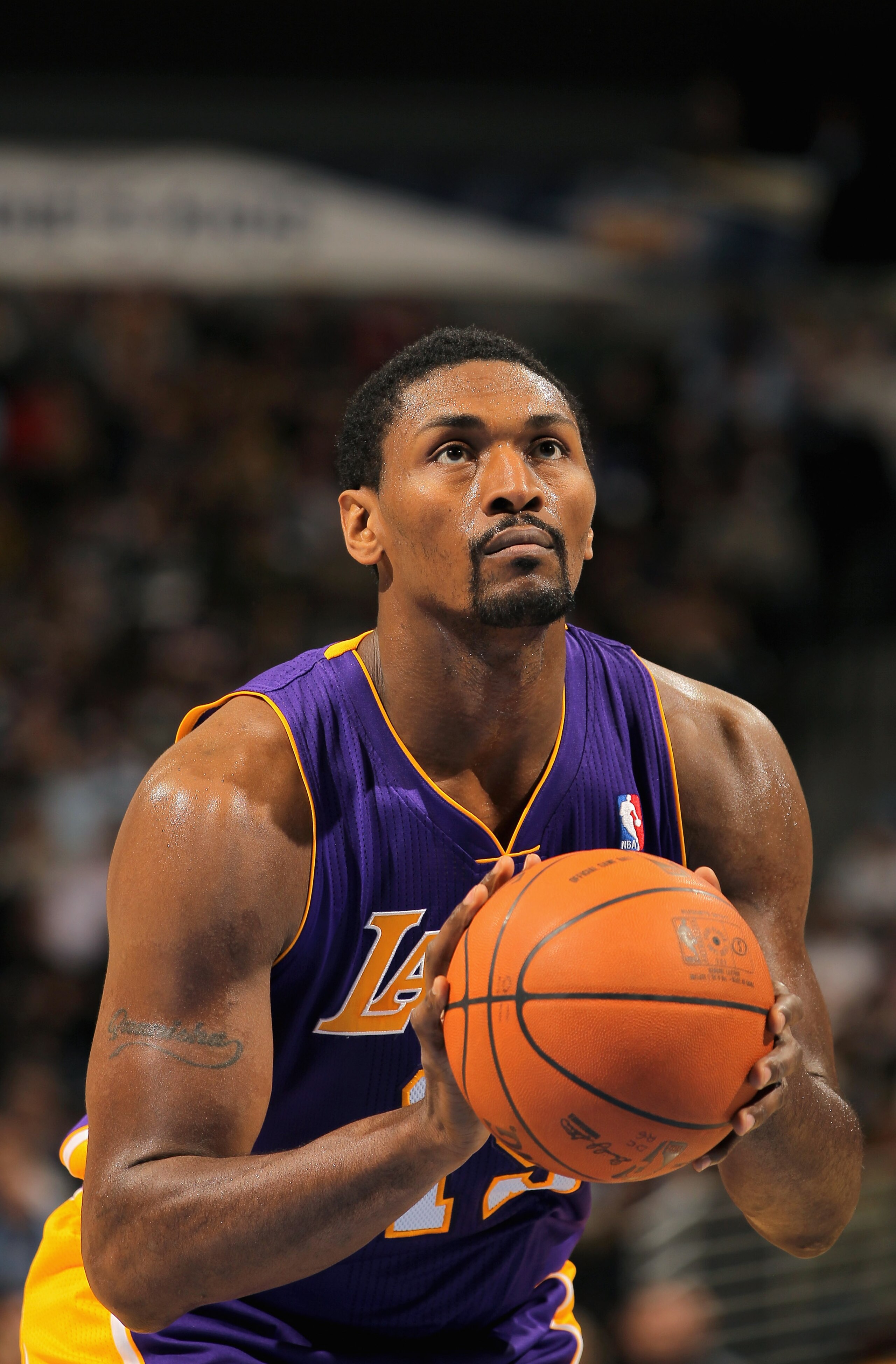DENVER - NOVEMBER 11:  Ron Artest #15 of the Los Angeles Lakers takes a free throw against the Denver Nuggets at the Pepsi Center on November 11, 2010 in Denver, Colorado. The Nuggets defeated the Lakers 118-112.  NOTE TO USER: User expressly acknowledges