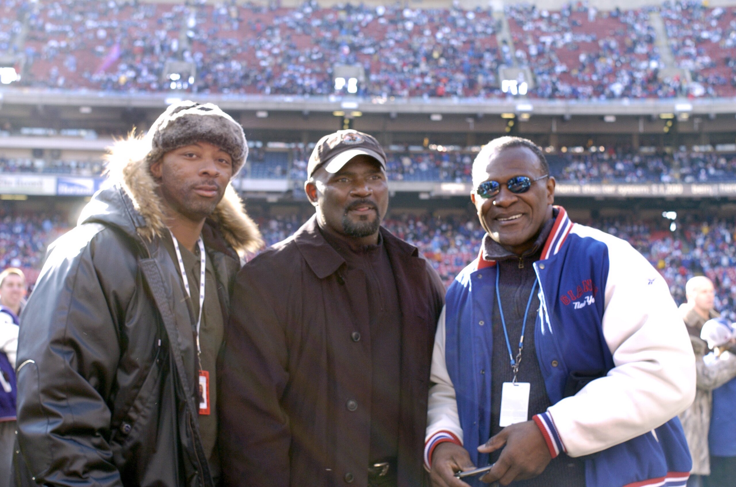 Former New York Giants L-R: Carl Banks, Lawrence Taylor and Harry Carson on the sidelines before an NFC wildcard game January 8, 2006 at the Meadowlands.  The Carolina Panthers defeated the Giants 23 - 0.  (Photo by Al Messerschmidt/Getty Images)