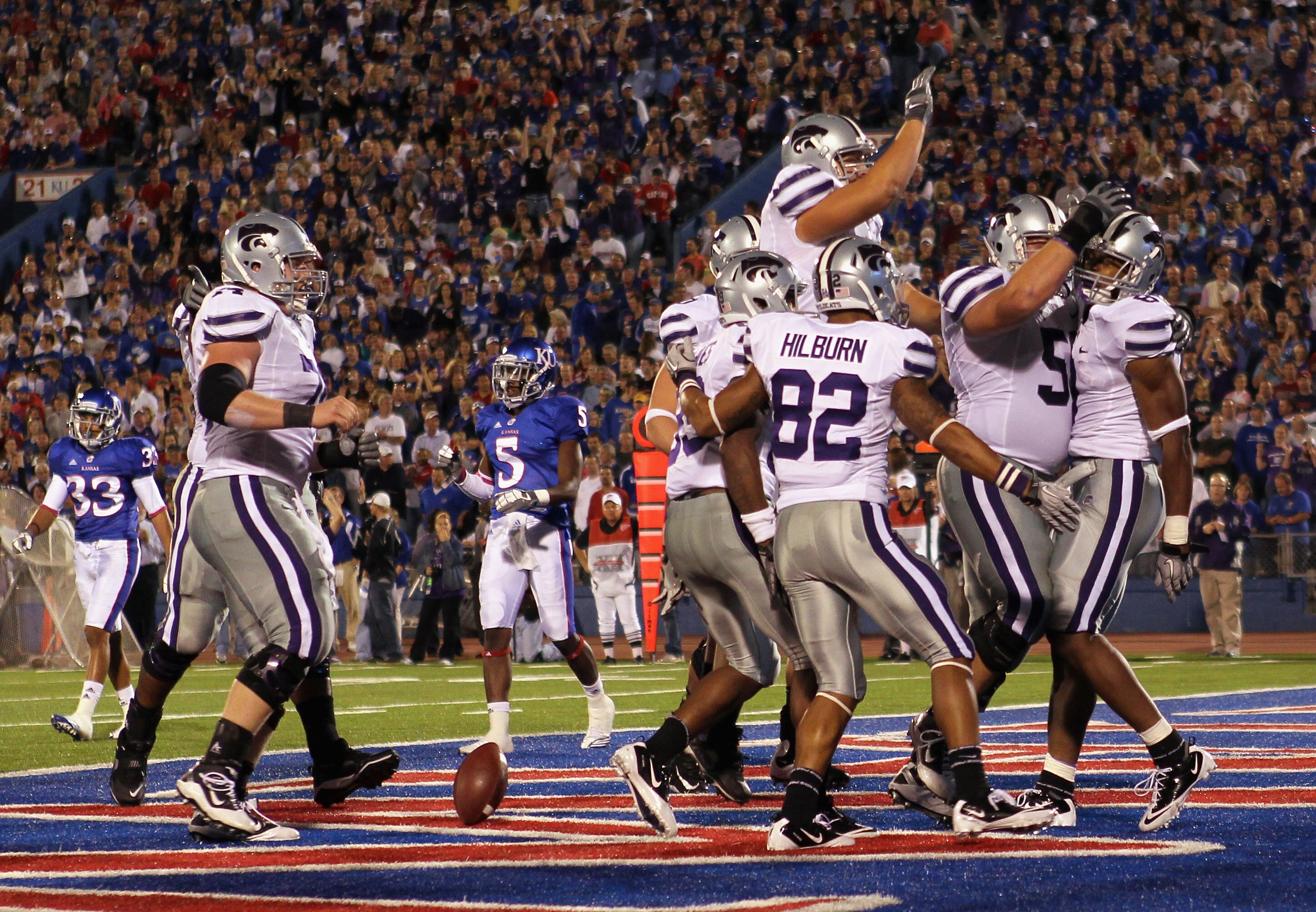 LAWRENCE, KS - OCTOBER 14:  Daniel Thomas #8 of the Kansas State Wildcats is congratulated by teammates after scoring a touchdown during the game against the Kansas Jayhawks on October 14, 2010 at Memorial Stadium in Lawrence, Kansas.  (Photo by Jamie Squ